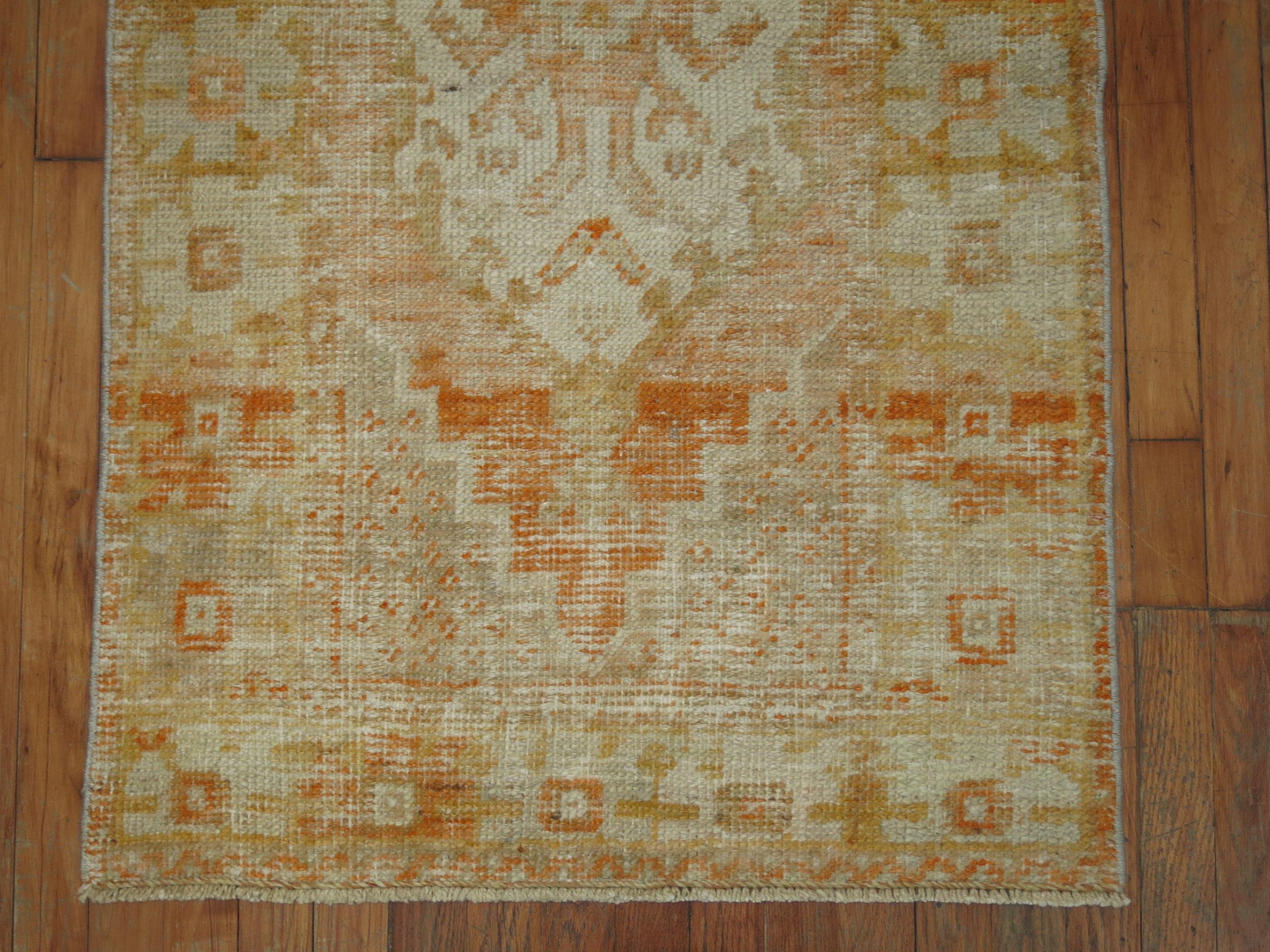 Shabby chic Turkish rug with pops of orange.

2'8'' x 4'9''
