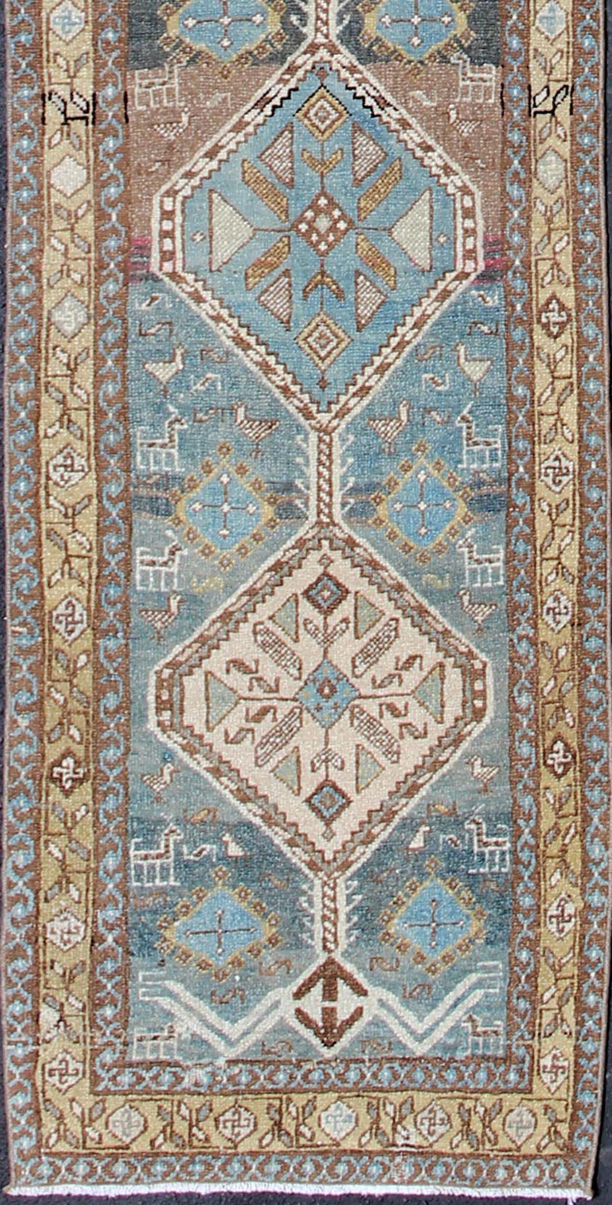 Persian Heriz antique Gallery rug with sub-geometric Medallion Design in colorful tones including blue, nude, and brown, rug sus-1807-215, country of origin / type: Iran / Heriz, circa 1920

This antique Persian Heriz runner, from northwest Iran,