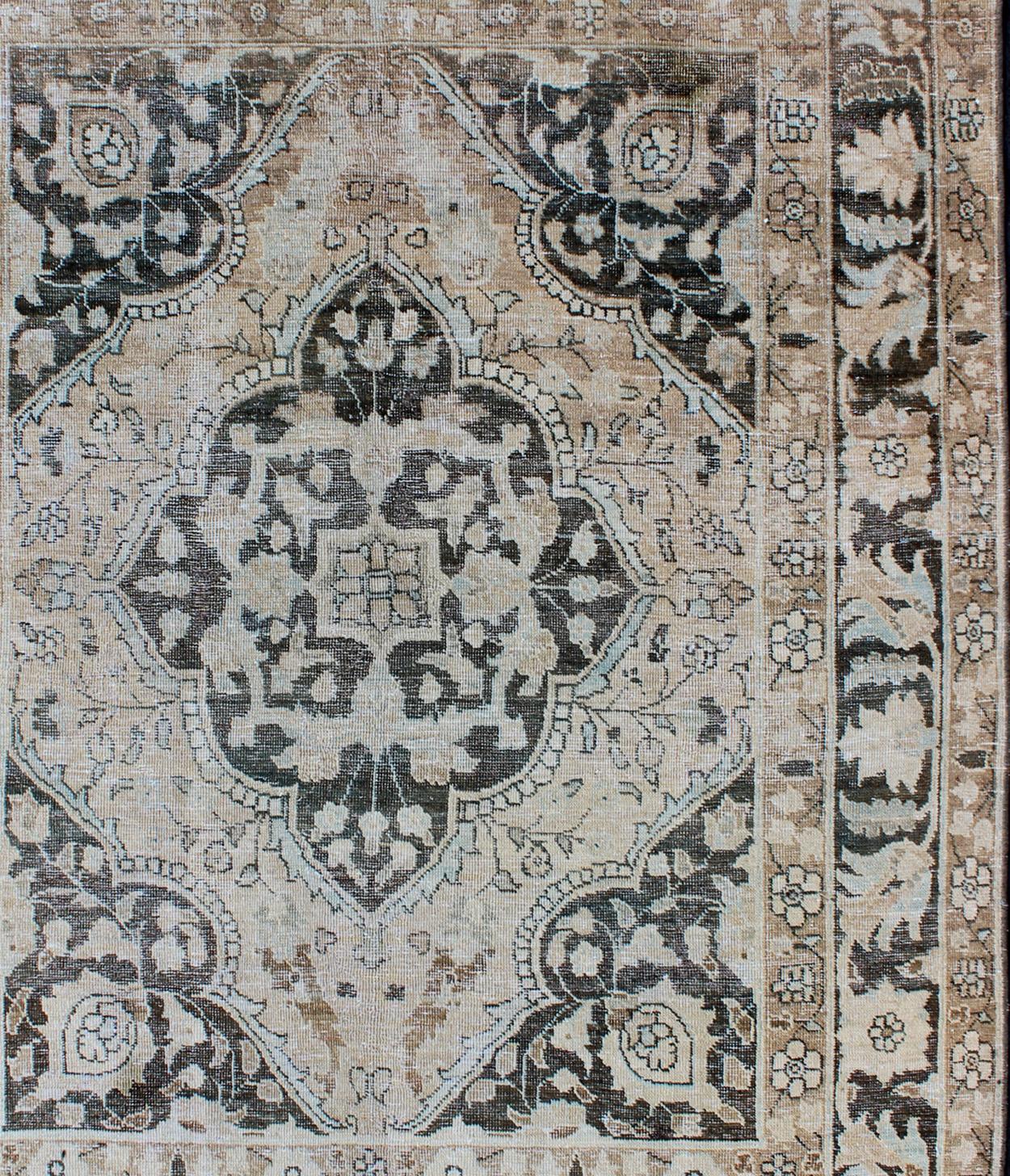   Antique Persian Tabriz Rug with Geometric Medallion Design in D. Charcoal, Light Honey, Light blue & Taupe. 

Measures: 4'6 x 6'

This wonderful antique Persian Tabriz with geometrics and flora  in dark gray medallion, cornices and border Keivan