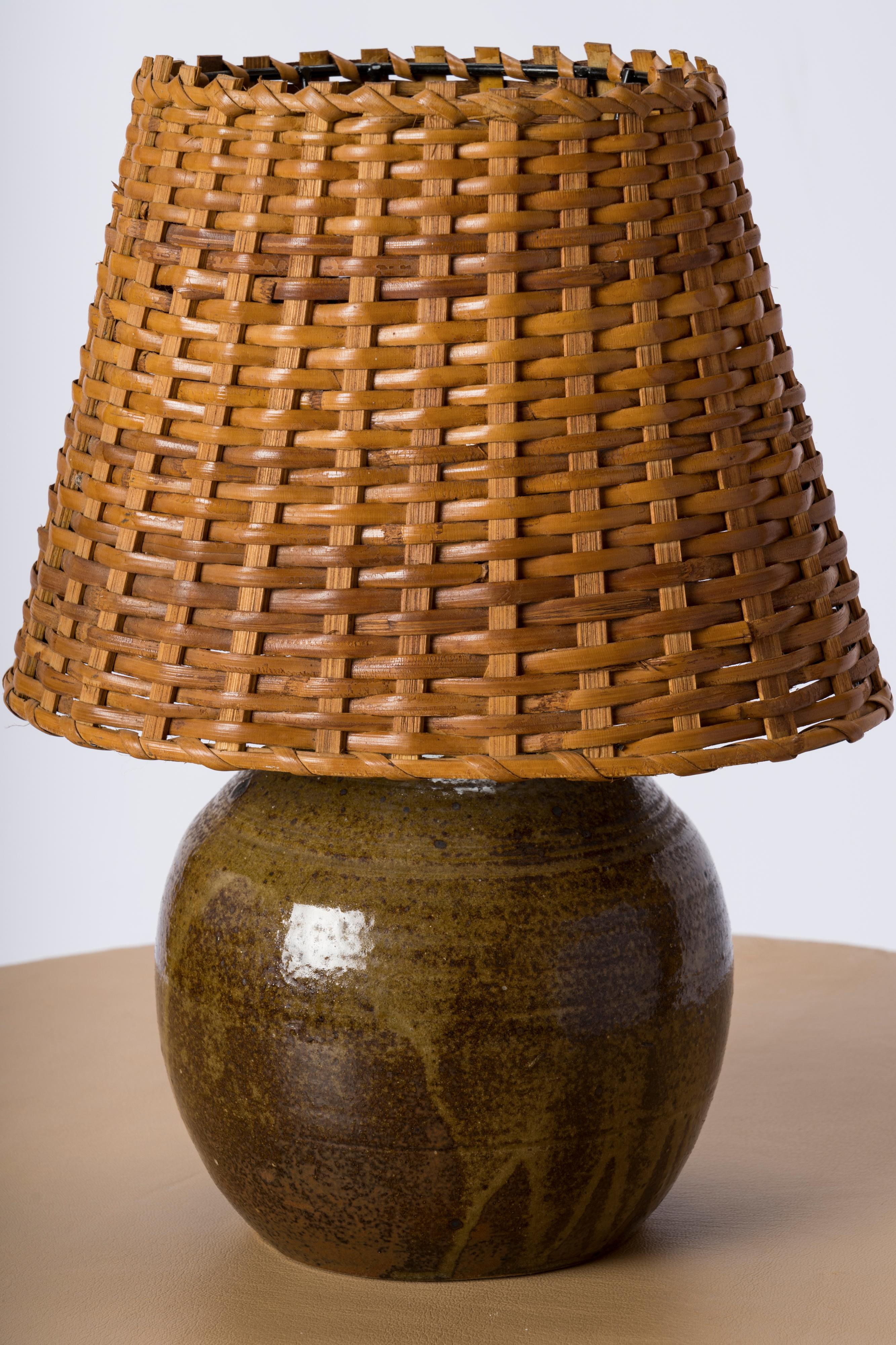 Chic petite glazed ceramic table lamp with braided wicker shade. Nuances of greens and browns. France 1970's.
European socket and wiring.
This lamp will ship from France and can be returned to either France or to a LIC NY location.
Price does not