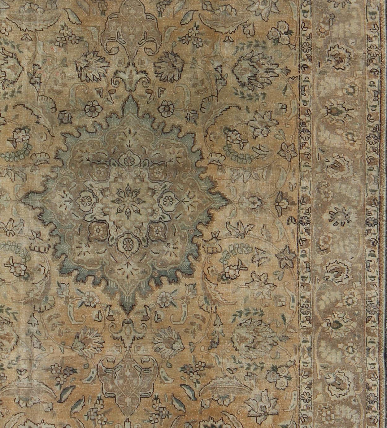 Persian rug Tabriz style with floral medallion design in Shades of Tan, Taupe, cream and tan, rug H-703-02, country of origin / type: Iran / Tabriz, circa 1950.

This Persian Tabriz carpet (circa 1950) features a refined palate of various shades