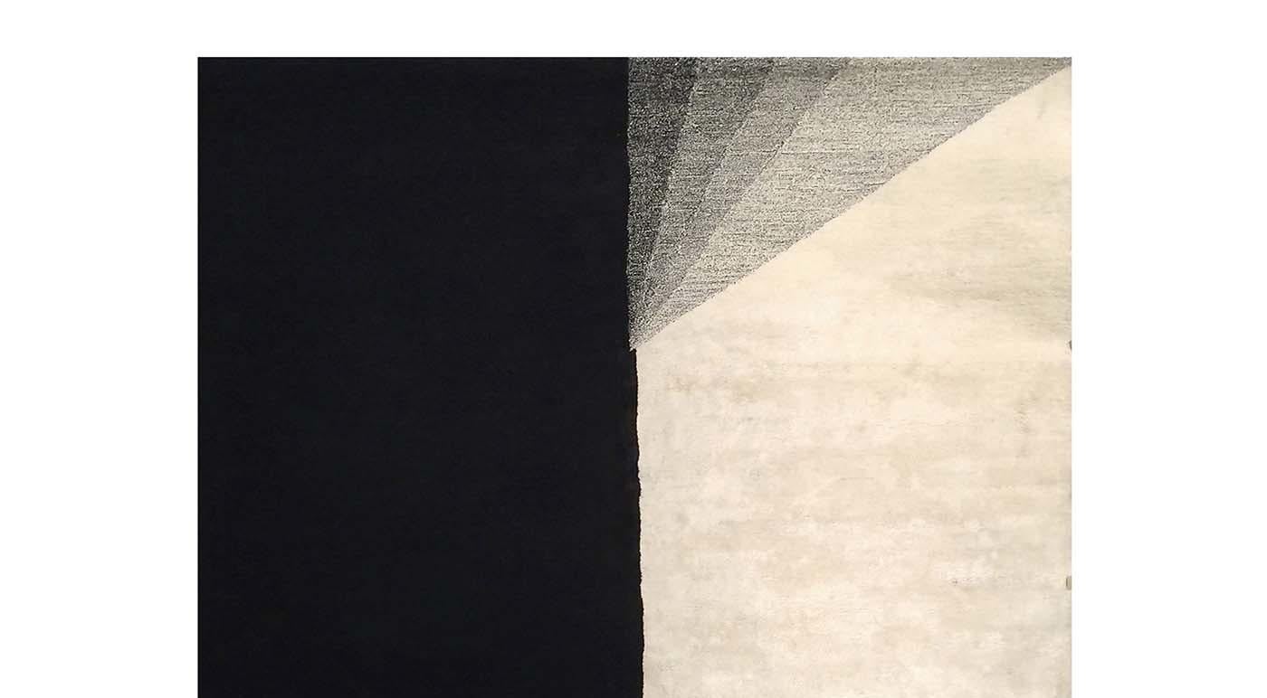 This exquisite rug is knotted by hand in Nepal by master craftsmen who have been collaborating with Illulian since 1959. Its striking design is composed of 20% silk and 80% Himalayan wool. The black, gray, and white color palette is refined and