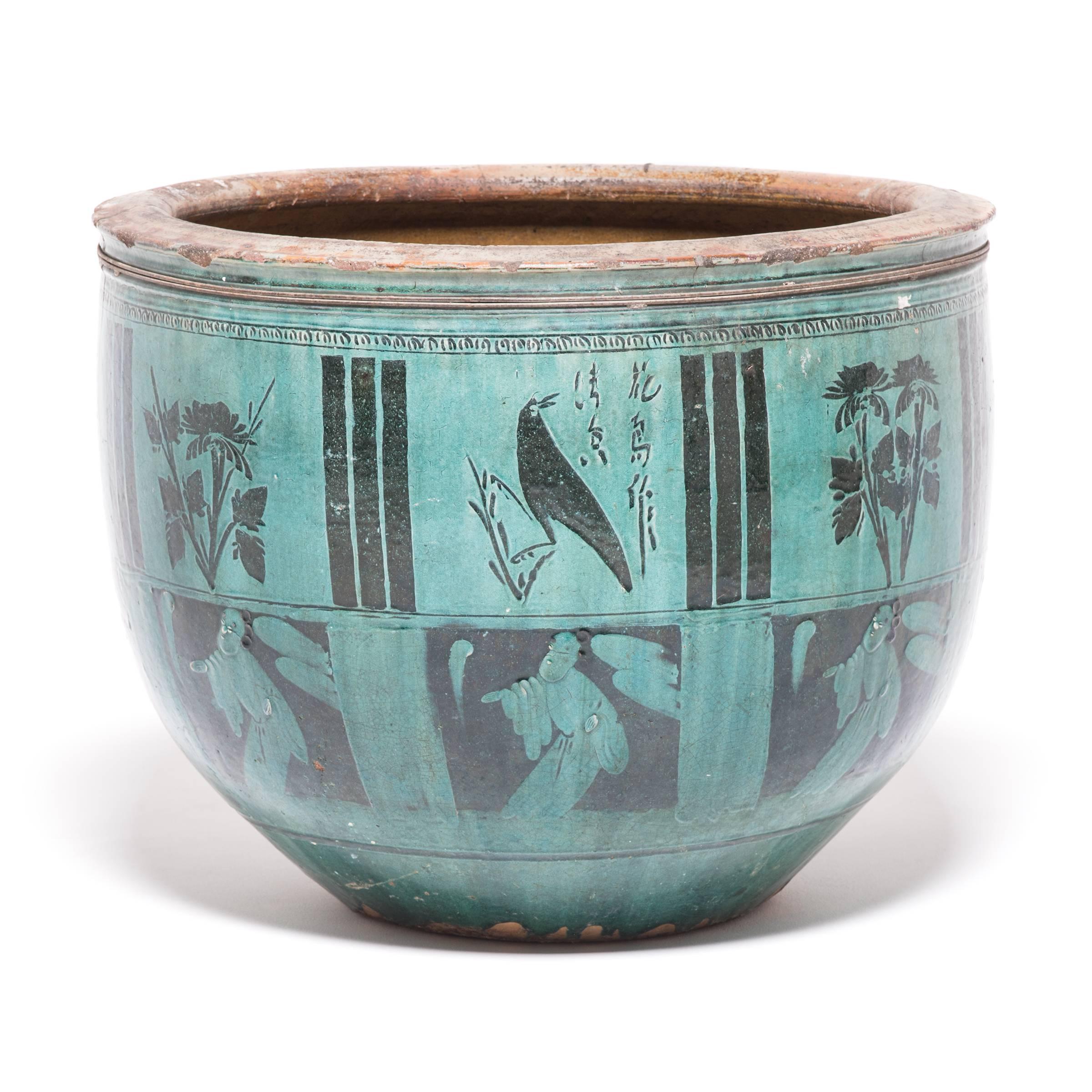 Like red- and black-figure pottery created by ancient Greeks, this striking container alternates two decorative techniques that make careful use of positive and negative space. Atop an under layer of jade green glaze, the vessel's upper panels