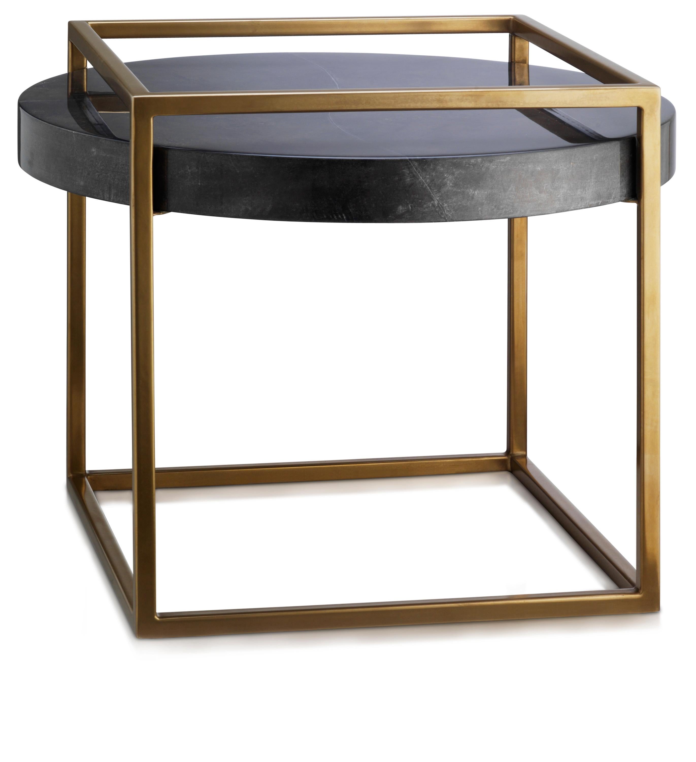 Beautiful curves contrast with the elegantly proportioned lines of the brushed gold metal frame.

Available in two sizes, the shadow side table is exquisitely finished using centuries-old techniques of handcrafted and hand-dyed parchment, in moon