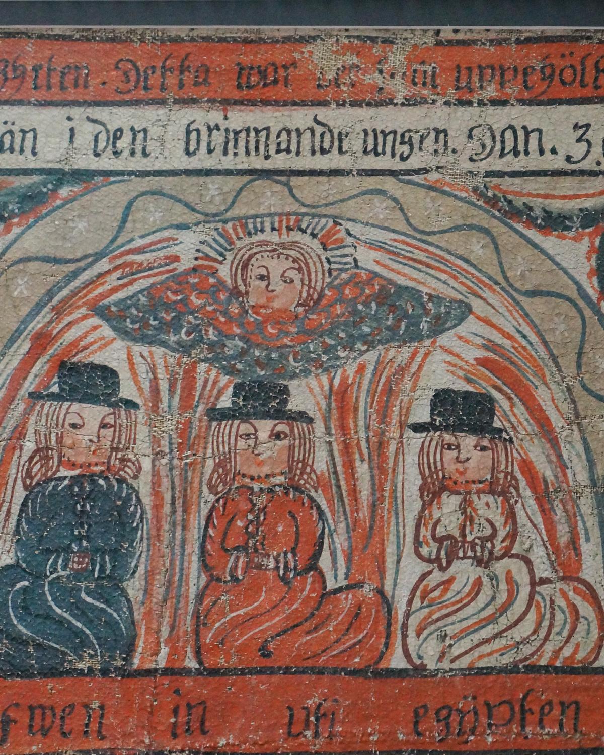 Fragment of a bonad, Sweden dated 1818, showing three kneeling figures surrounded by fire and protected by a hovering angel. Note the misspelling of “ugnen”, furnace, as “ungen.” Below is a partial row of kneeling men, probably Joseph’s brothers.