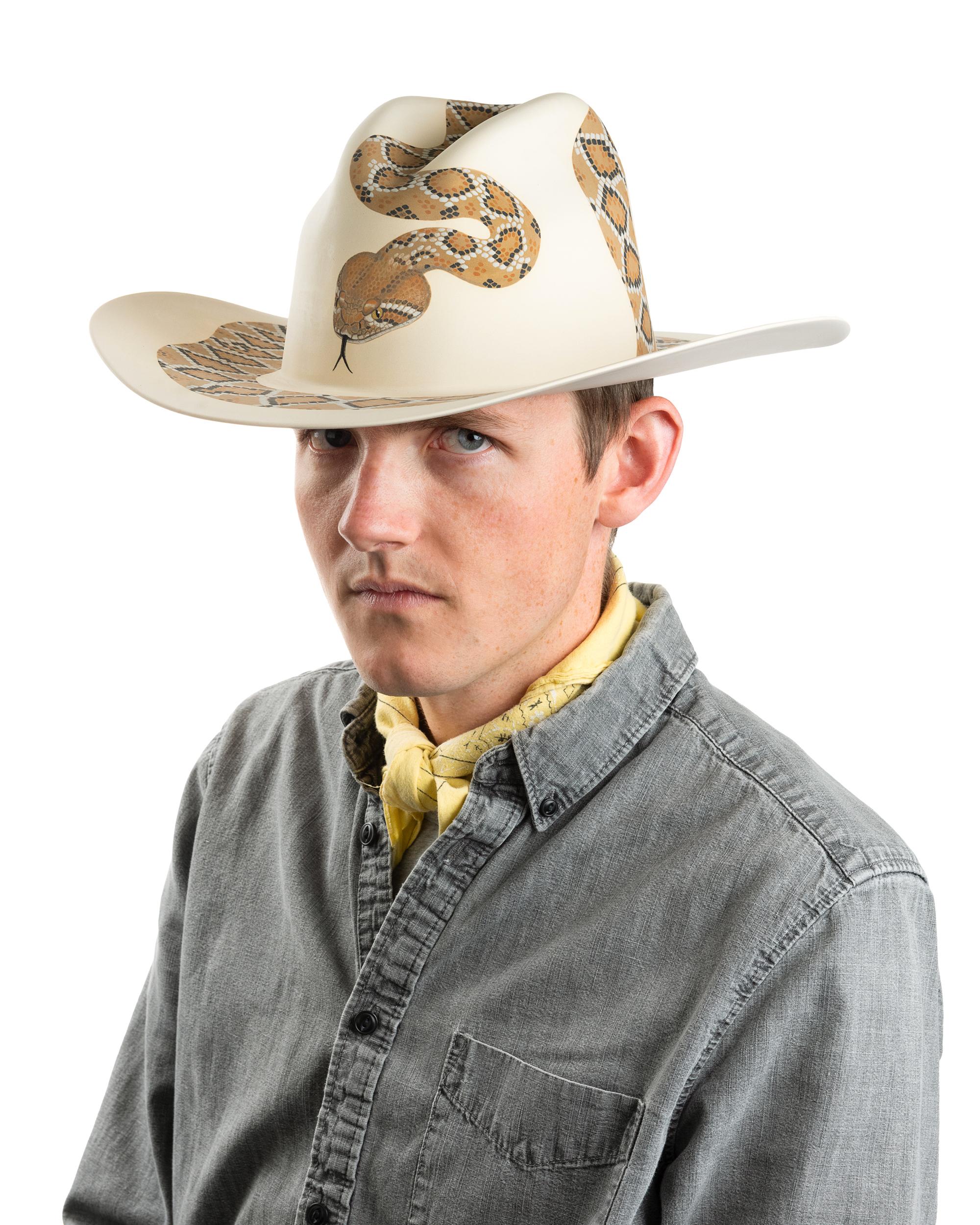 This is a ceramic cowboy hat. Crotalus depicts a diamondback rattlesnake. This piece is about the rattlesnake specifically as an icon in the mythology of the American frontier, and, more generally, snakes unfair vilification as a quintessential