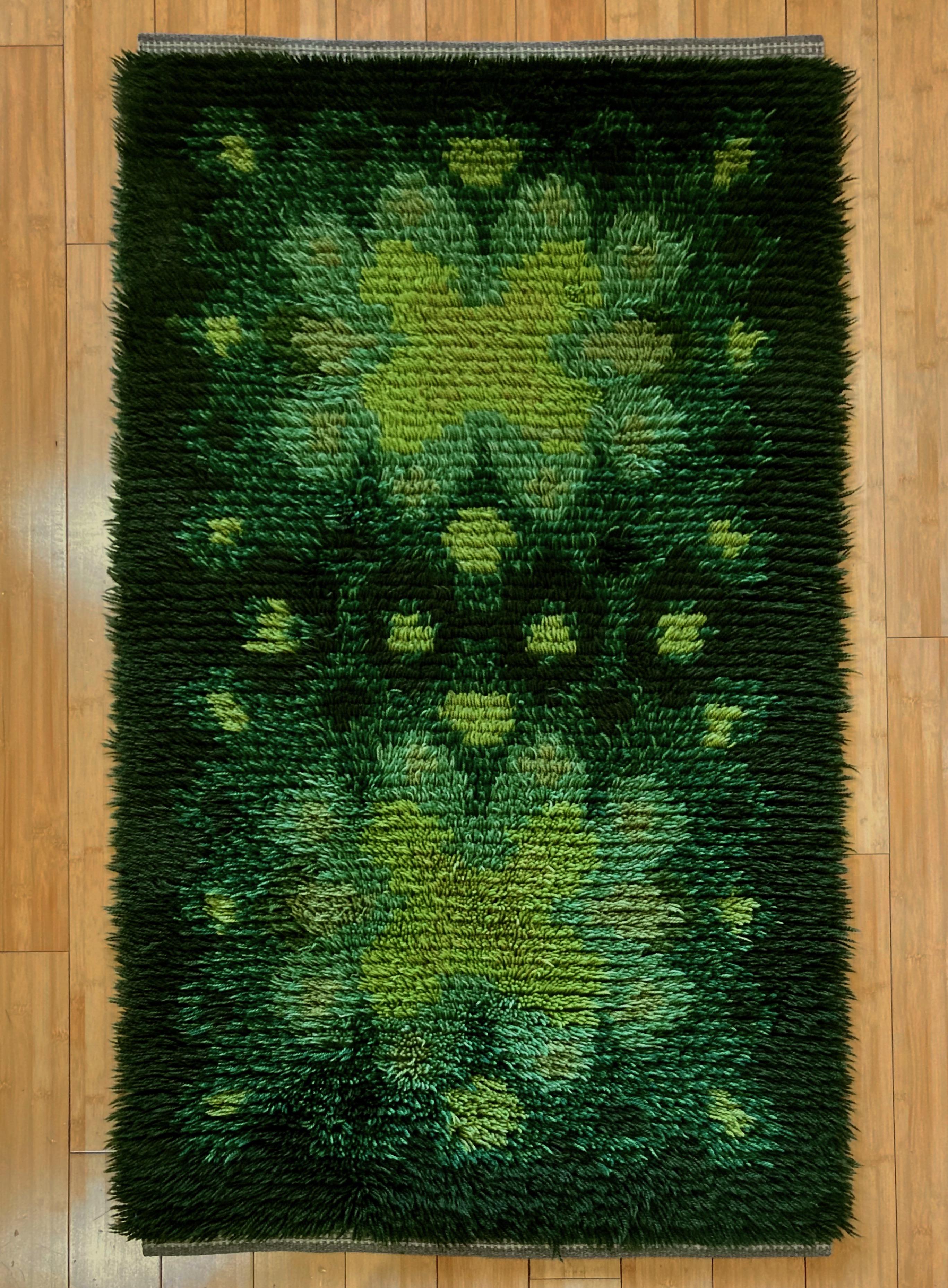 A vintage high pile Scandinavian rya rug crafted of hand knotted wool in many shades of green, dating circa 1960s. This midcentury rya is a soft and cozy accent for the floor but could be slung over a chair or hung on the wall as textile artwork.