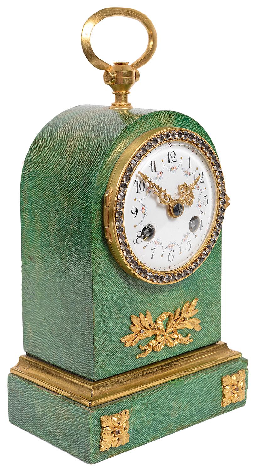 A very pleasing late 19th century French arched top mantel, carriage clock in green Shagreen, with a gilded ormolu handle to the top, crystal jewels to the bezel, an eight day duration chiming clock movement, gilded ormolu leaf and ribbon mount and