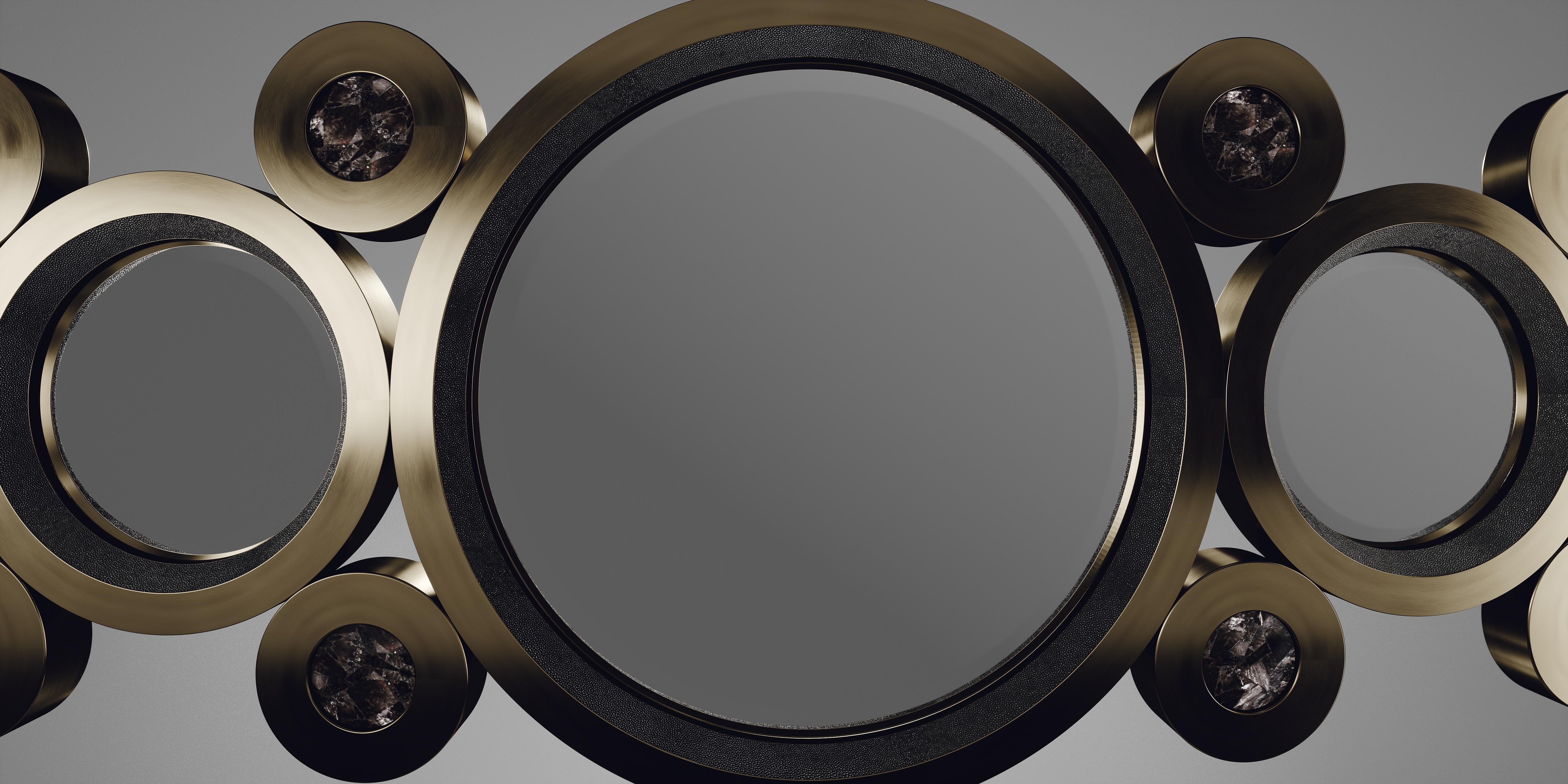 The circle mirror by R&Y Augousti in coal black shagreen, black quartz and dark bronze-patina brass, is an archive piece of theirs from the 1990s. The statement wall piece adds drama and flair to any space and shows the richness of their incredible