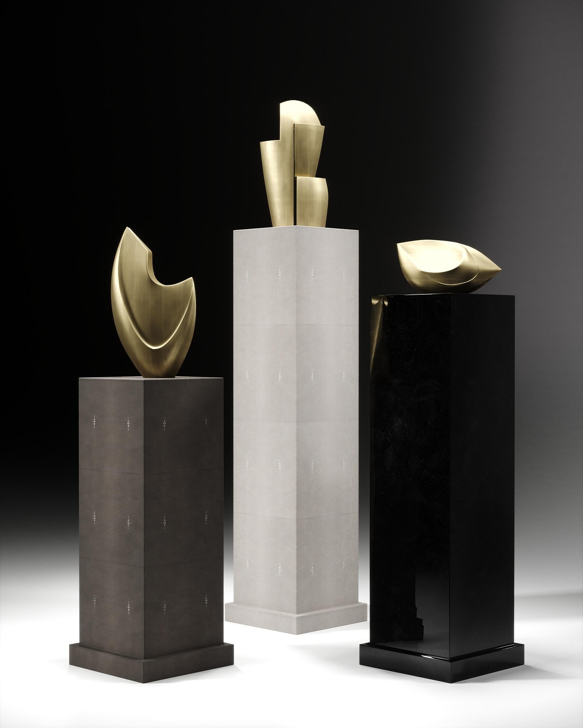 This set of 3 columns inlaid in cream shagreen, coal black shagreen and black pen shell by R&Y Augousti and 3 bronze-patina brass abstract sculptures by Patrick Coard Paris, is the ultimate luxury accent pieces for any space. Options to purchase