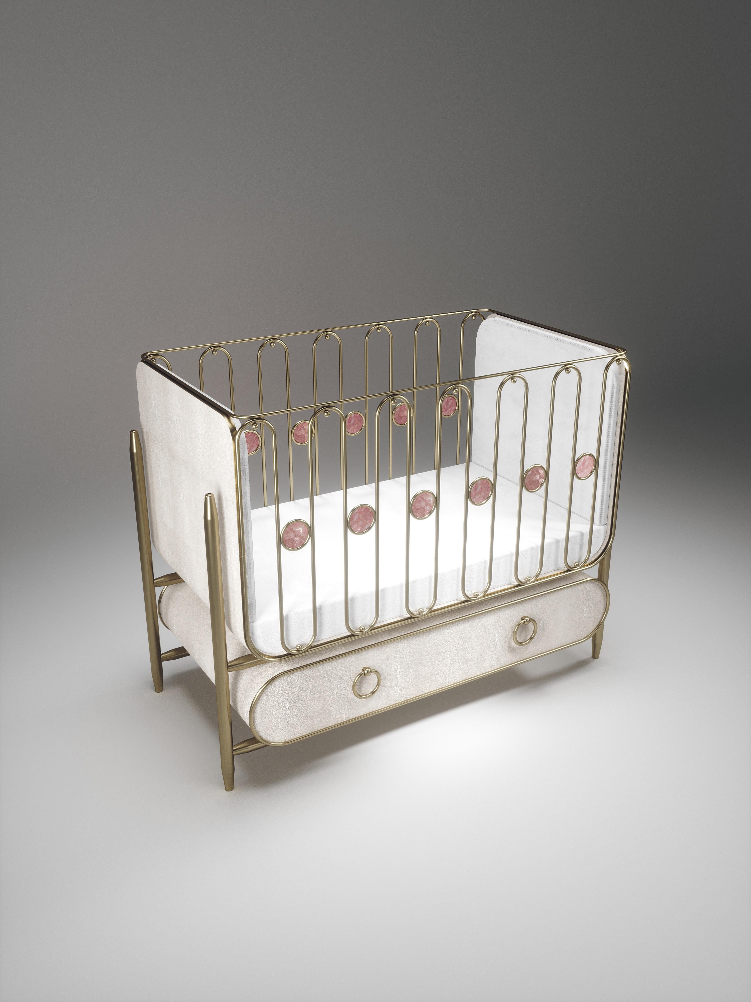 The Riviera Baby Crib by Kifu Paris is the ultimate luxury piece for your child's bedroom. Inspired by the birth of her first child, Kifu Augousti designed this piece to embrace the whimsical world of a child. The piece is inlaid in cream shagreen