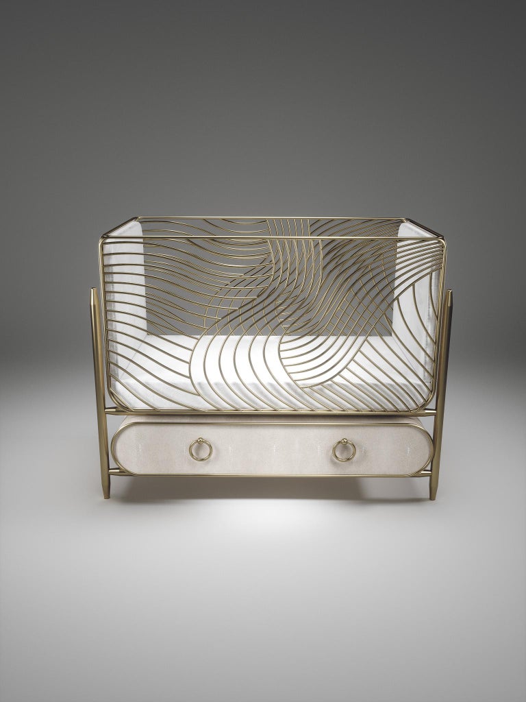 The storm baby crib by Kifu Paris is the ultimate luxury piece for your child's bedroom. Inspired by the birth of her first child, Kifu Augousti designed this piece to embrace the whimsical world of a child. The piece is inlaid in cream shagreen