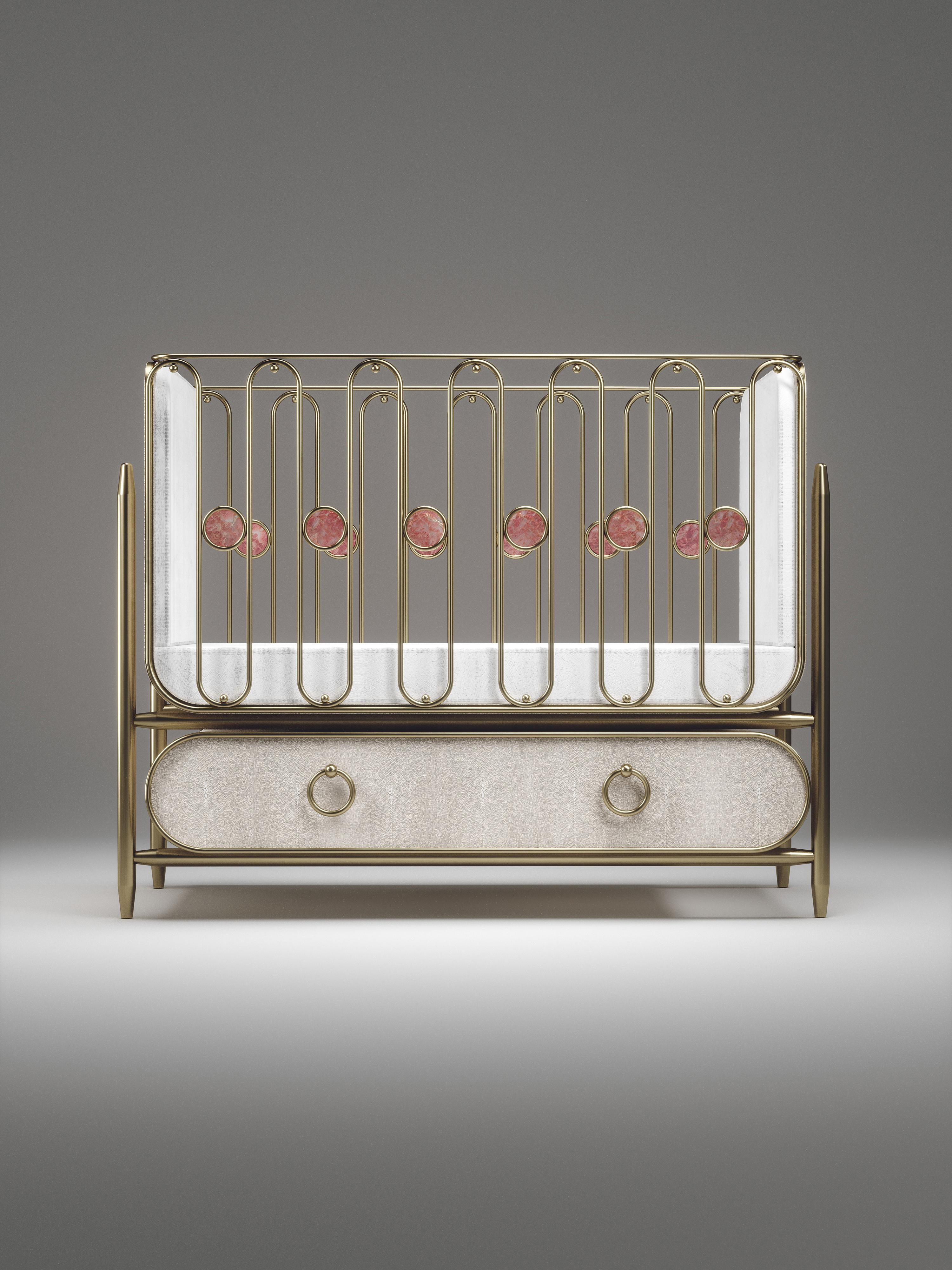 The Riviera baby crib by Kifu Paris is the ultimate luxury piece for your child's bedroom. Inspired by the birth of her first child, Kifu Augousti designed this piece to embrace the whimsical world of a child. The piece is inlaid in cream shagreen