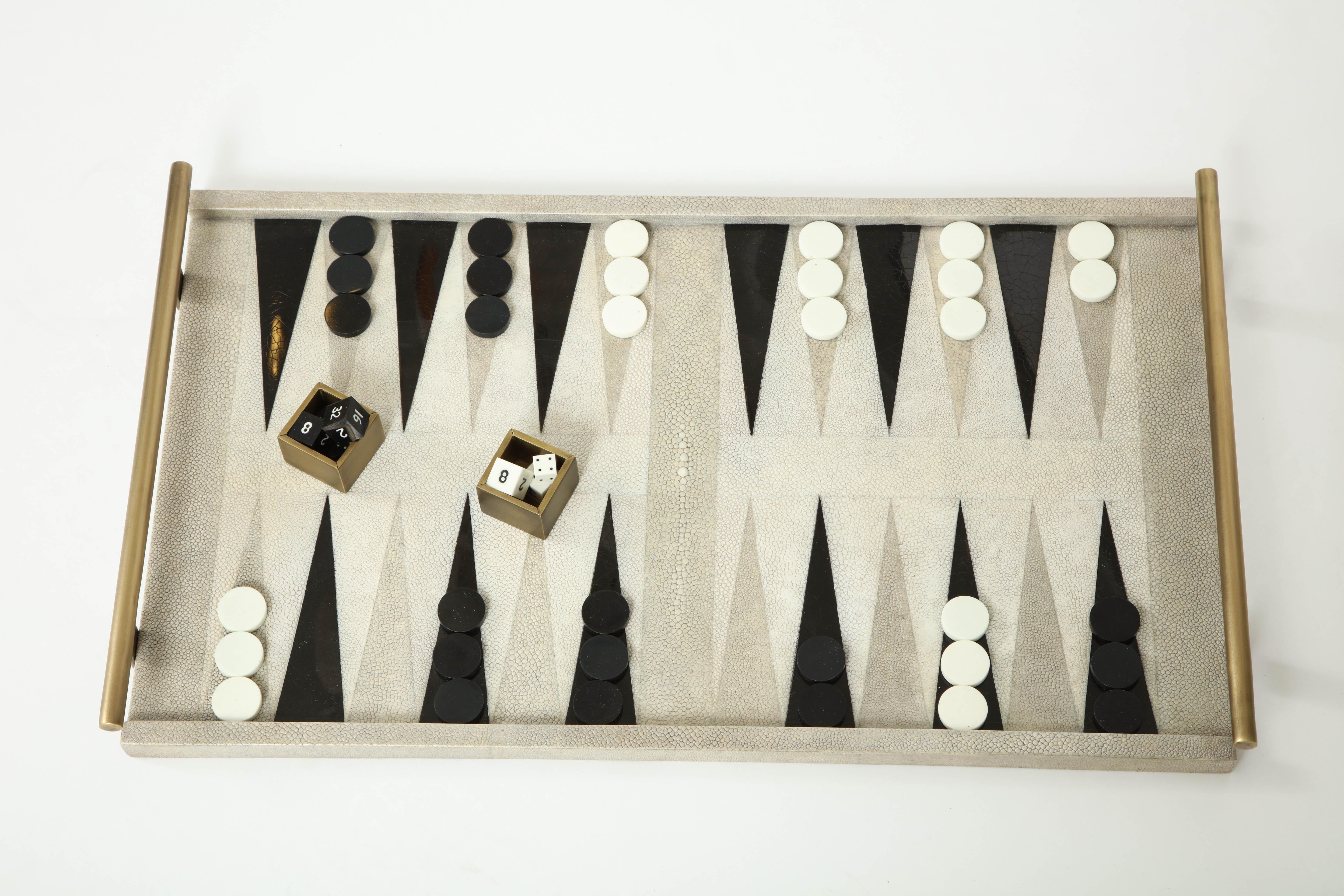 Decorative backgammon game made of shagreen, black sea shell and brass details.
Delivery time is about 8-10 weeks.
We have another game in stock with a darker shagreen. Please let us know and we will send pictures.