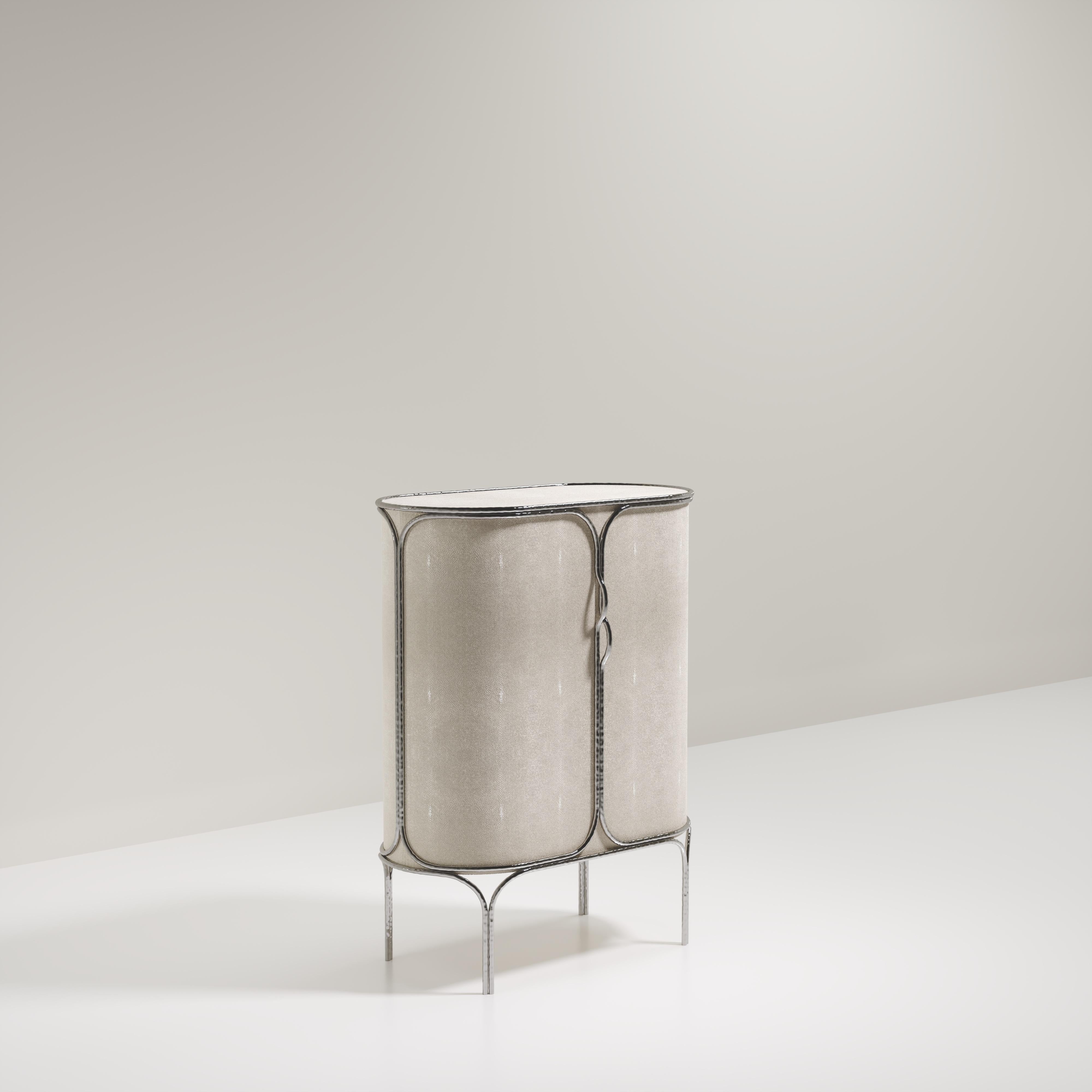 The Arianne bar cabinet by R&Y Augousti is one of a kind statement piece. The overall piece is inlaid in cream shagreen accentuated with intricate chrome finish polished stainless steel details that have the signature Augousti 
