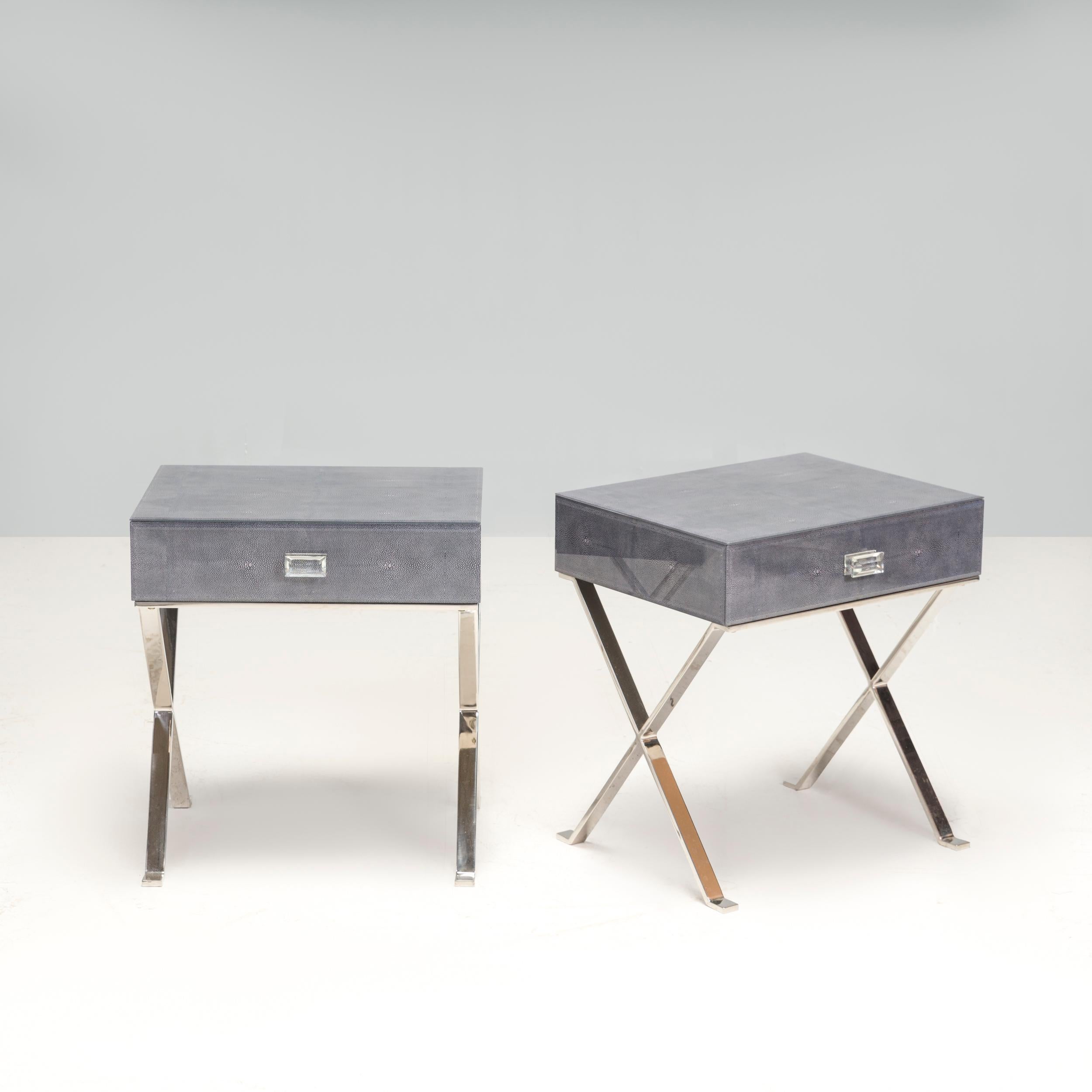 This modern bedside table will brighten up any bedroom. Featuring a trendy grey, faux cement finish, its boxy design contributes to its edgy style, as does the sleek chrome metal base. 

The unique structure of crossed legs also elevate the piece's