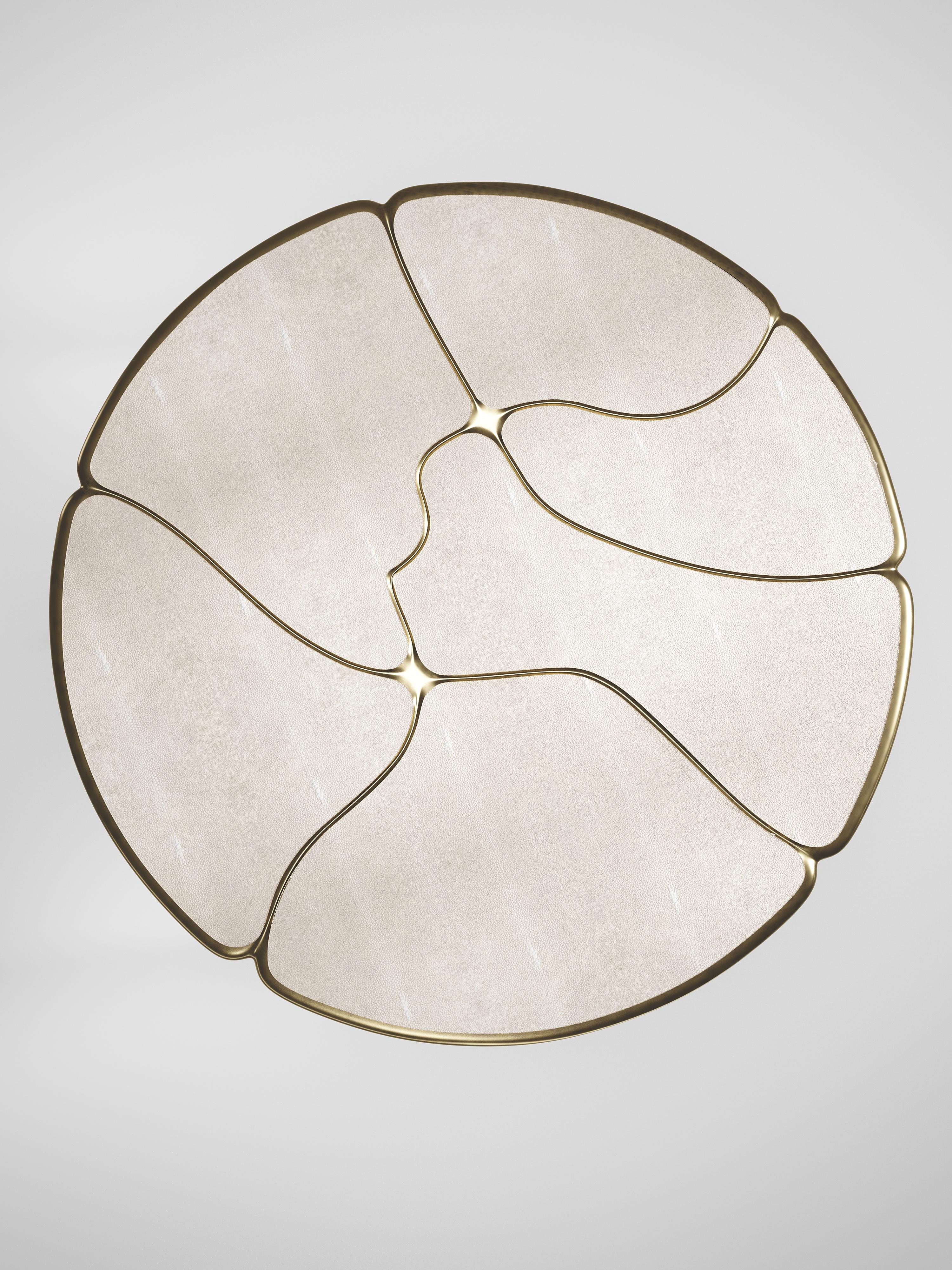 The Frequency breakfast table by R & Y Augousti is sleek piece with a vintage-modern feel. The piece explores fluid organic lines with subtle detailing to create the signature Augousti aesthetic. The piece is inlaid in a mixture of cream shagreen