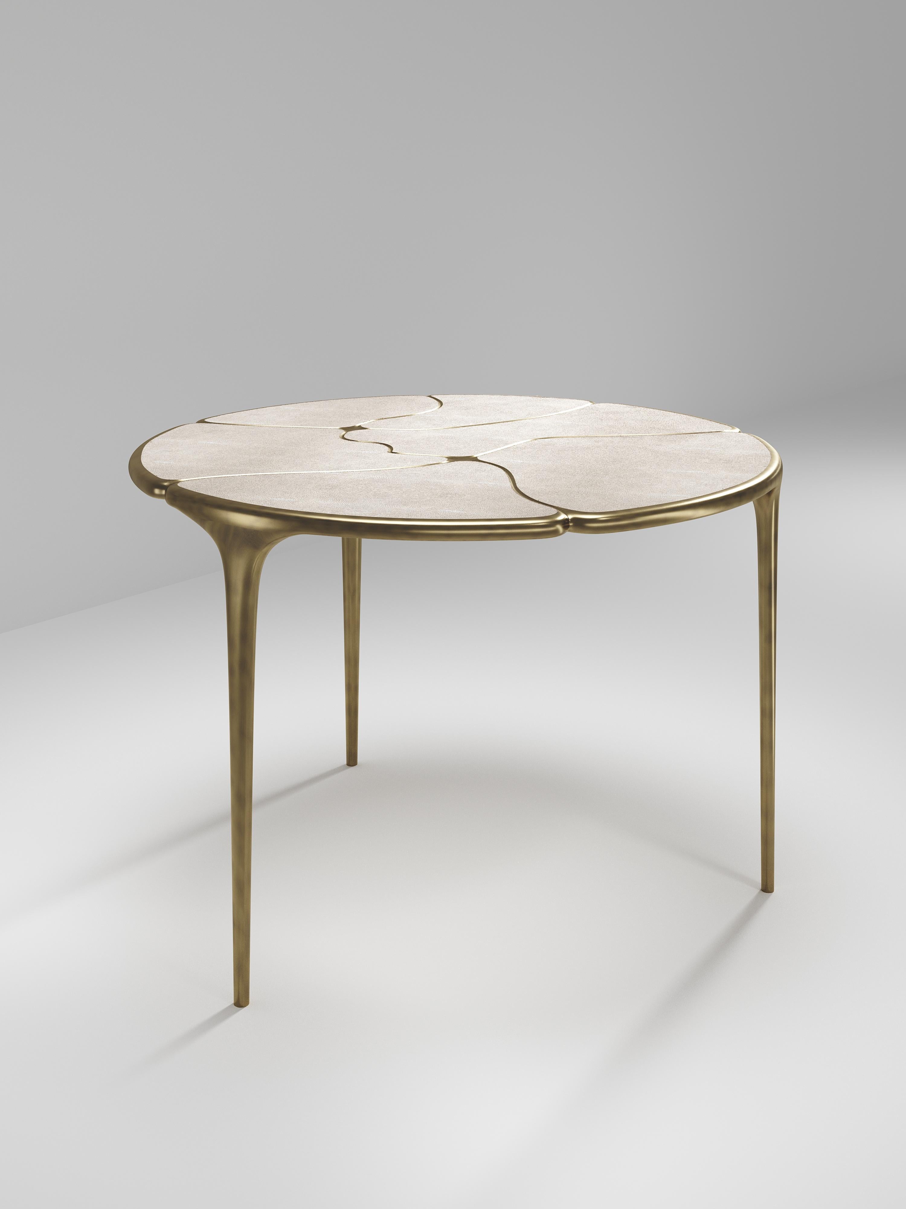 The Frequency breakfast table by R & Y Augousti is sleek piece with a vintage-modern feel. The piece explores fluid organic lines with subtle detailing to create the signature Augousti aesthetic. The piece is inlaid in a mixture of cream shagreen