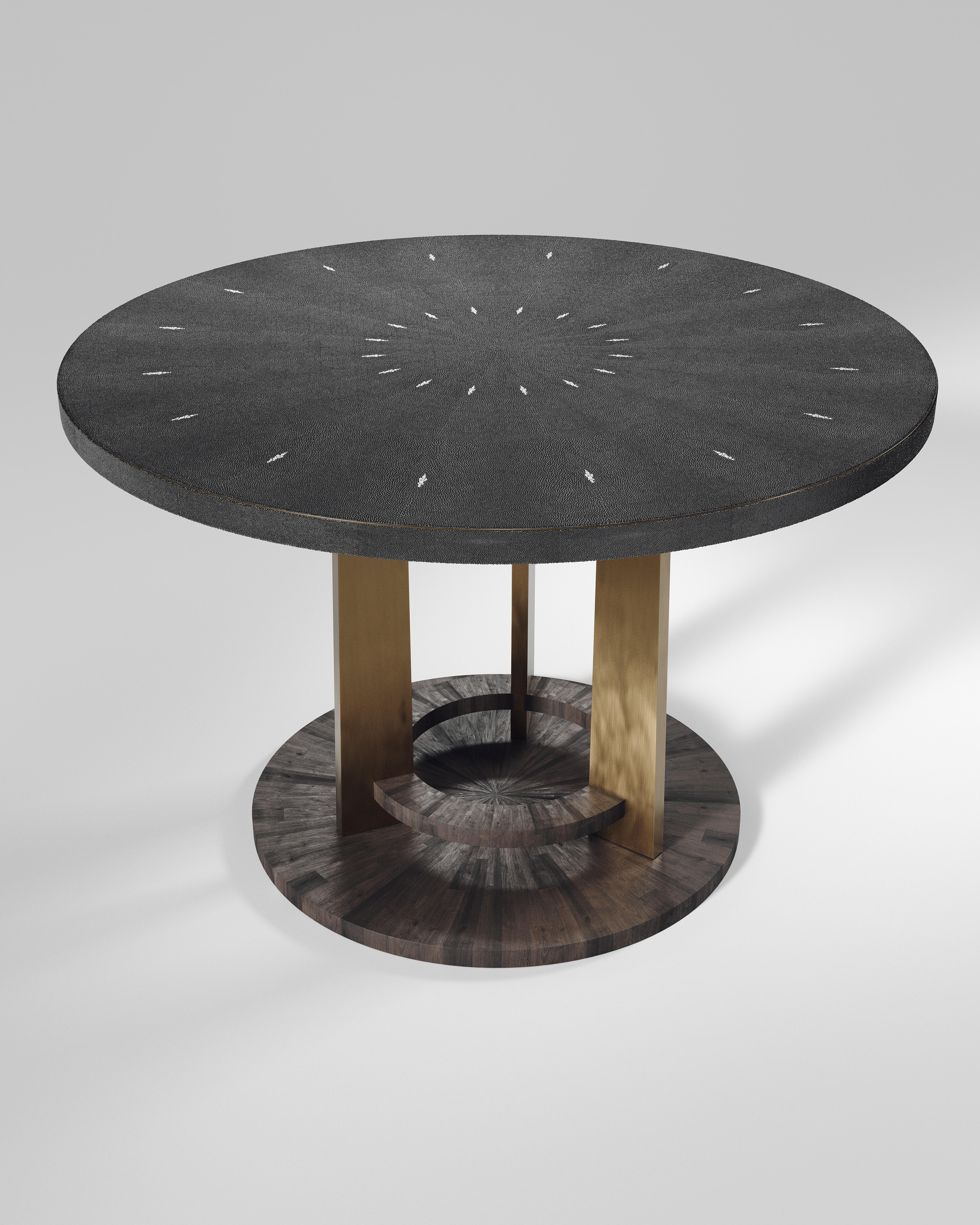 The Prague breakfast table by R&Y Augousti is an iconic design of their collection, debuting from the 1990s. This signature has been updated with metal accents on the border of the table and on the 3 legs. This classic center piece can be adapted