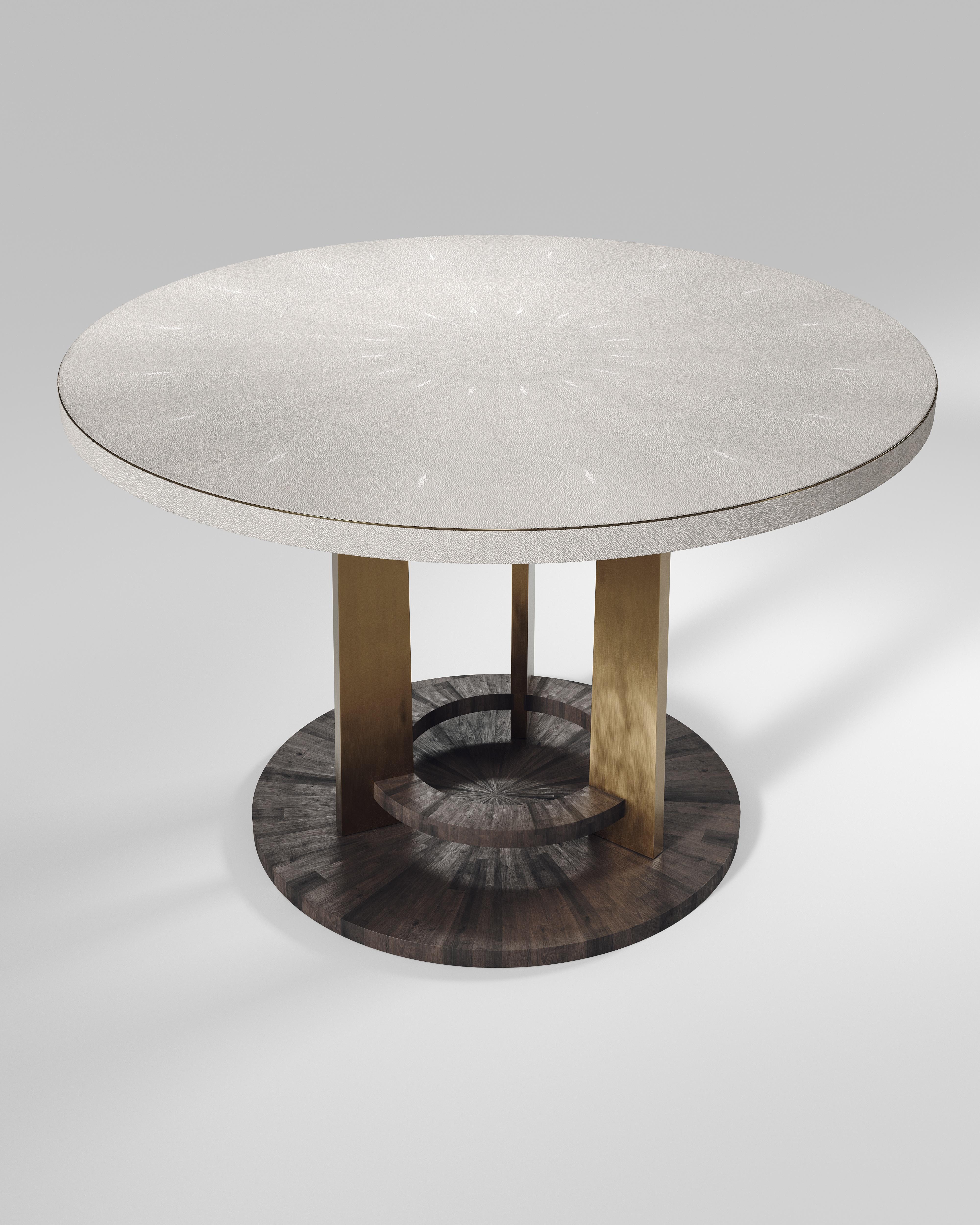 The Prague breakfast table by R&Y Augousti is an iconic design of their collection, debuting from the 1990s. This signature has been updated with metal accents on the border of the table and on the 3 legs. This classic center piece can be adapted