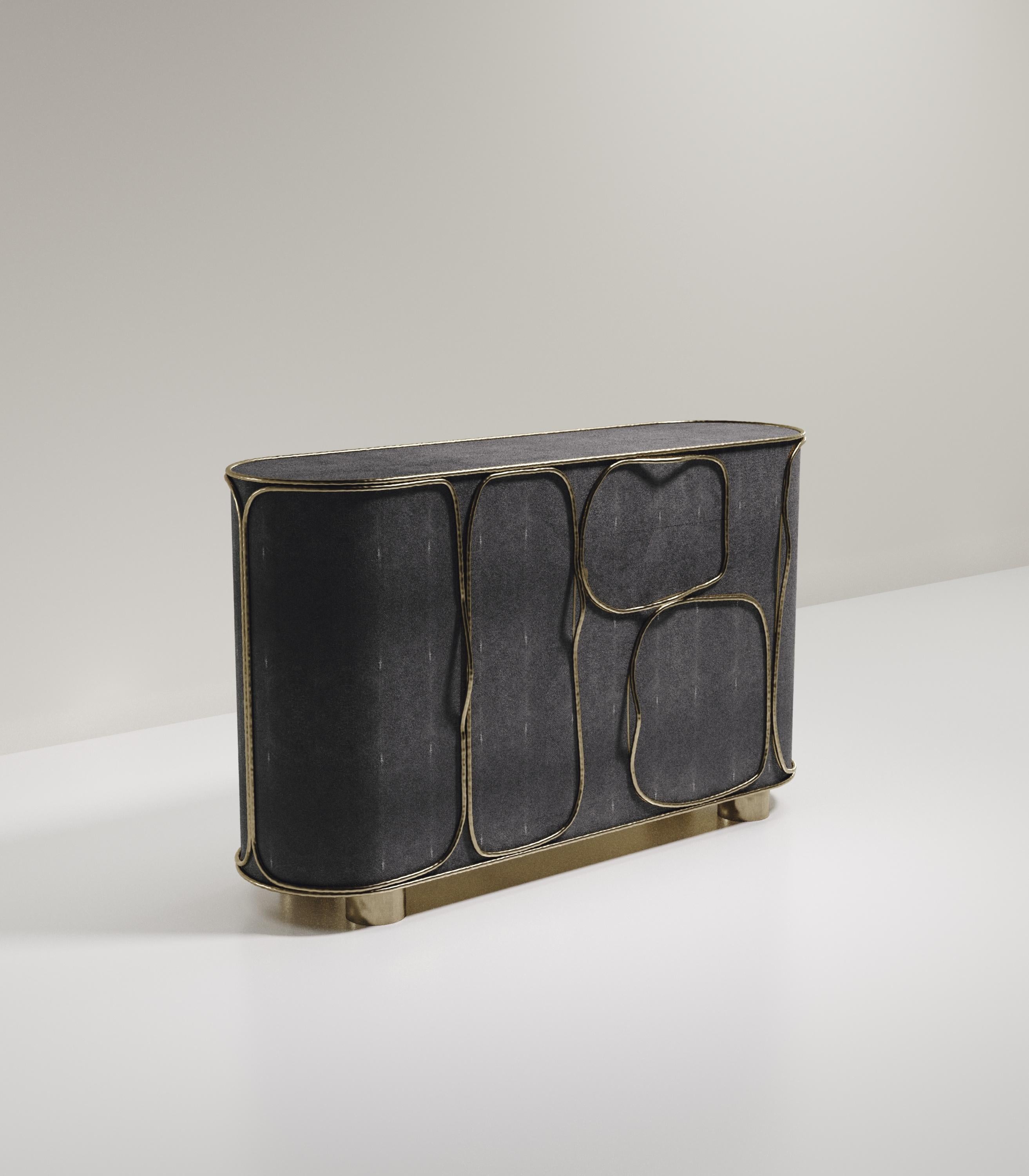 The Arianne buffet by R&Y Augousti is one of a kind statement piece. The overall piece is inlaid in coal black shagreen accentuated with intricate bronze-patina brass details that have the signature Augousti 