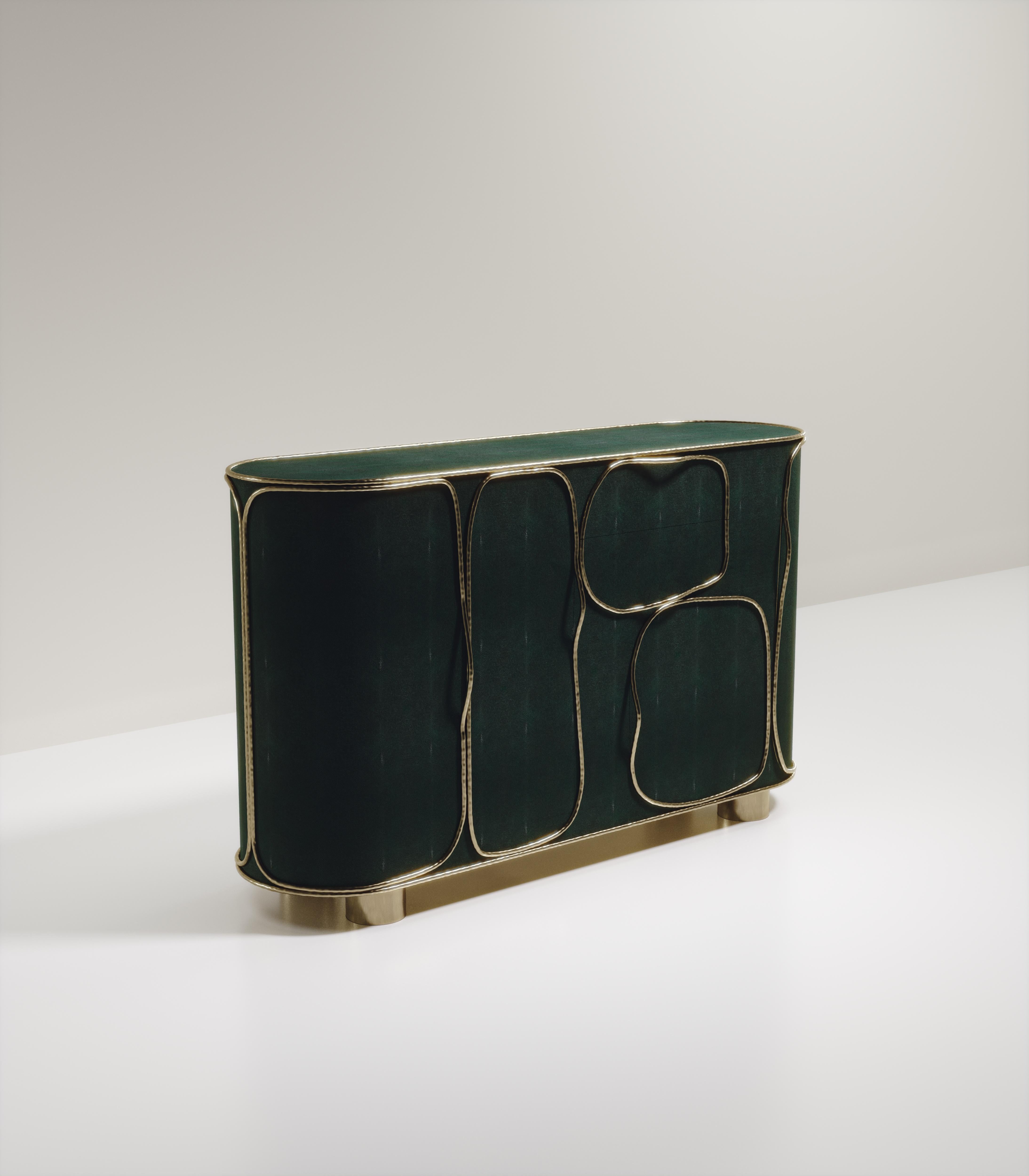 The Arianne buffet by R&Y Augousti is one of a kind statement piece. The overall piece is inlaid in green shagreen accentuated with intricate bronze-patina brass details that have the signature Augousti 