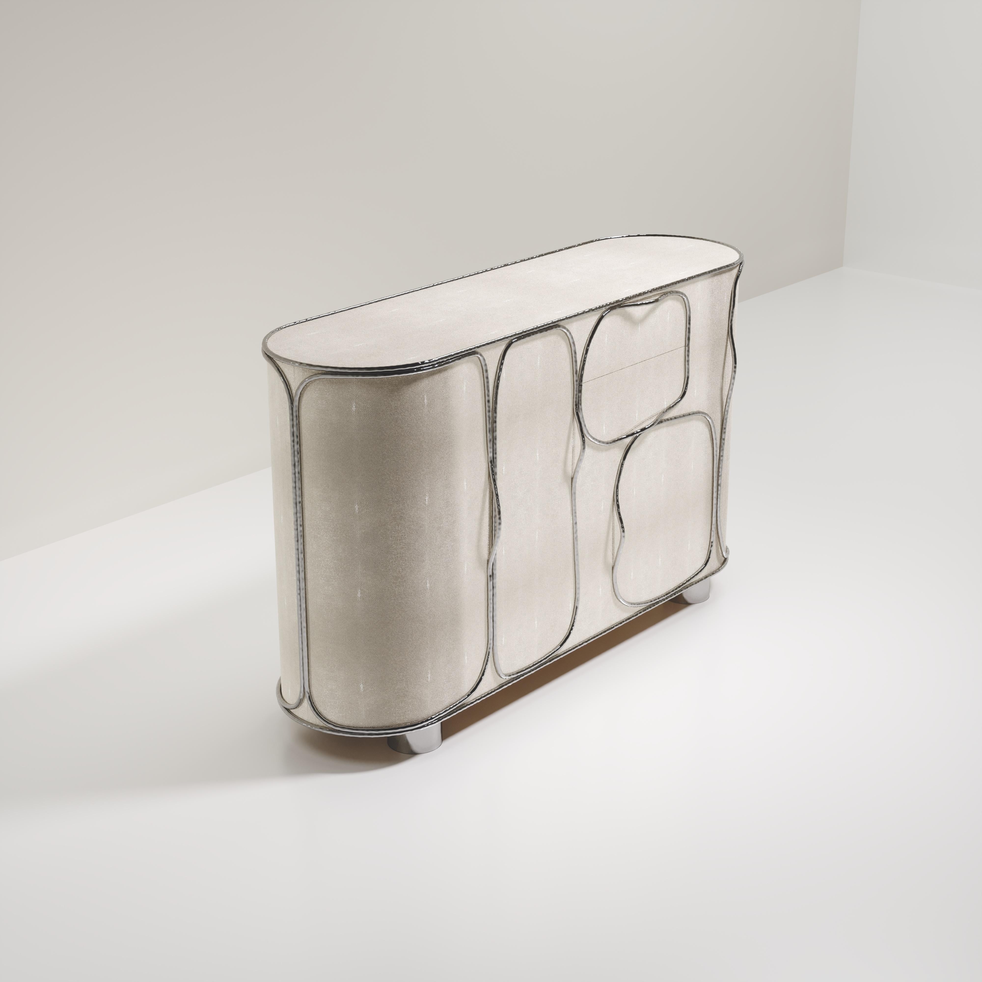 The Arianne buffet by R&Y Augousti is one of a kind statement piece. The overall piece is inlaid in cream shagreen accentuated with intricate chrome finish polished stainless steel details that have the signature Augousti 