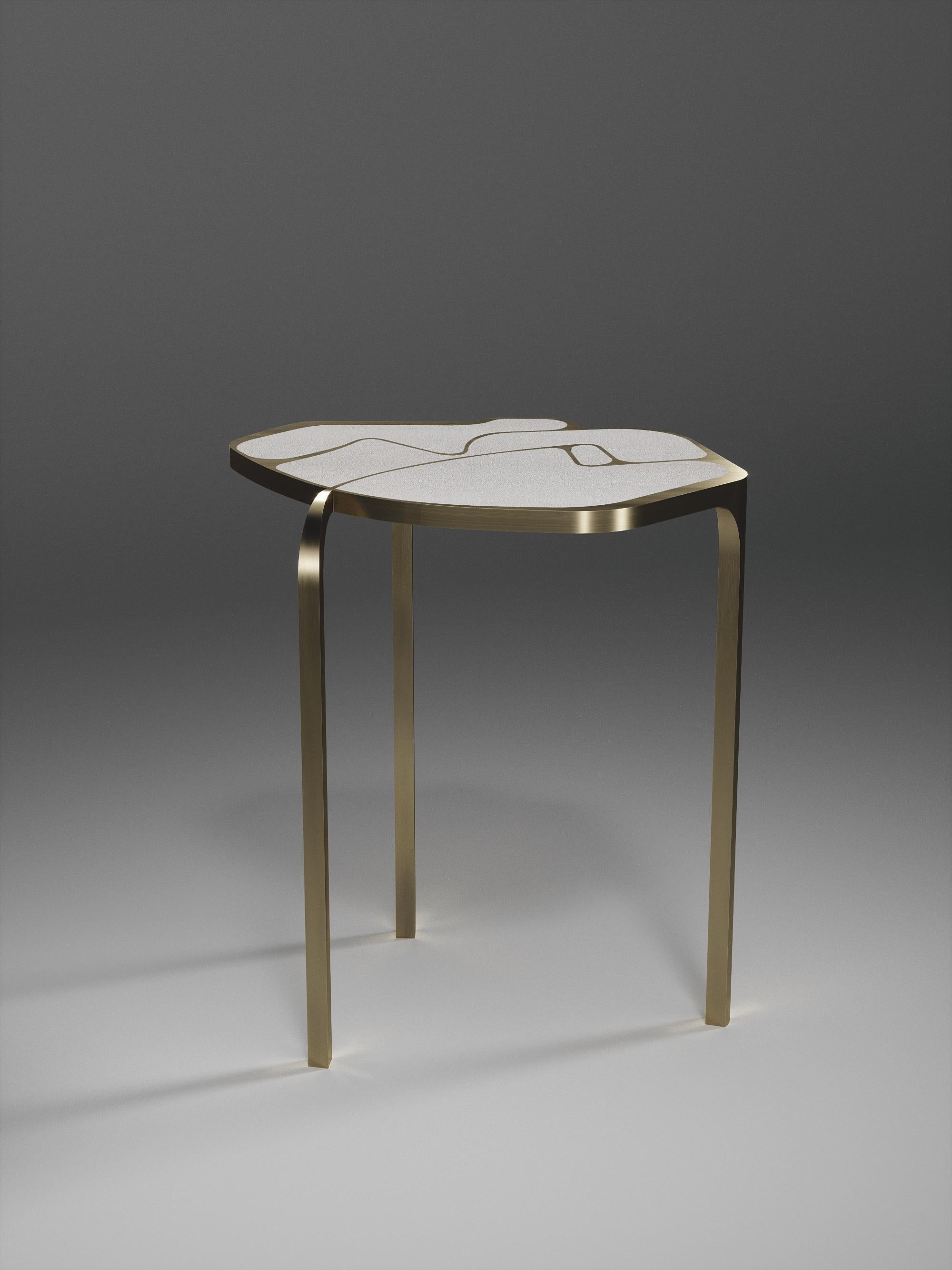 The Cocteau side table by R & Y Augousti is a truly one of a kind piece. The sculptural and ethereal piece has abstract forms, shapes and figures within it that one could interpret in different ways. The bronze-patina brass inserts in the cream