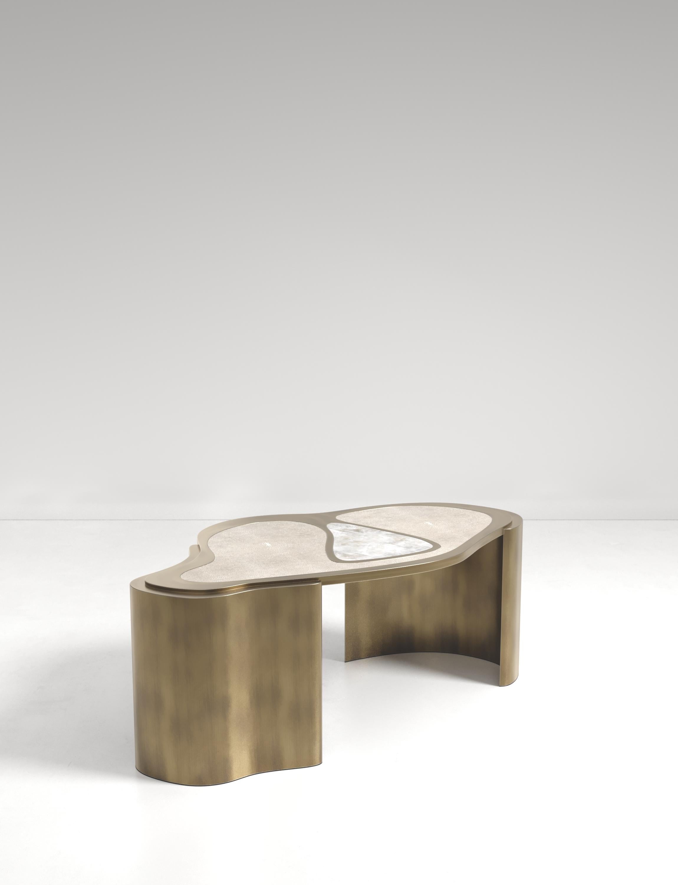 The Mask Coffee Table by Kifu Paris is a versatile and organic piece. The amorphous top and base are inlaid in a mixture of cream shagreen, white quartz and bronze-patina brass. This piece is designed by Kifu Augousti the daughter of Ria and Yiouri