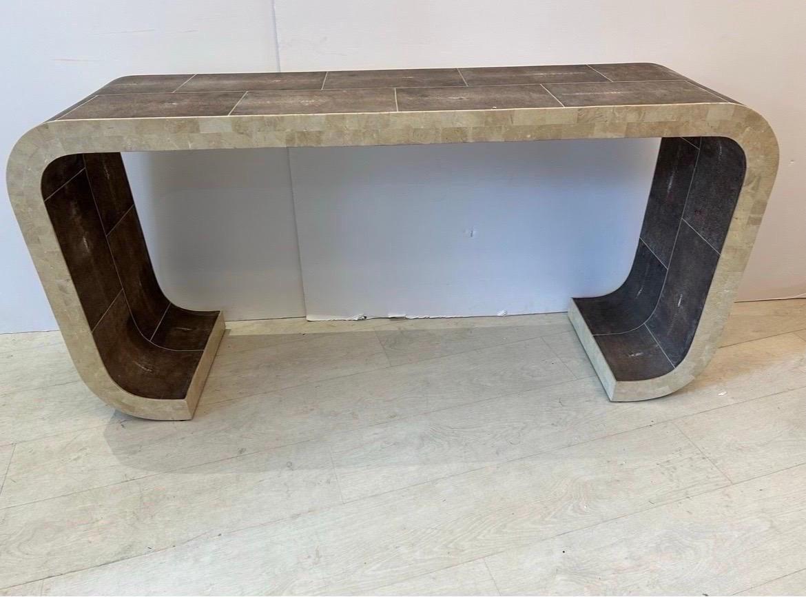 A shagreen console  table with curved ends, by Maitland Smith… The shagreen has lavender tones and the sides of the table have tessellated stone… unmatched quality in very good condition very unique…. Measurements are approximately 27 inches tall by