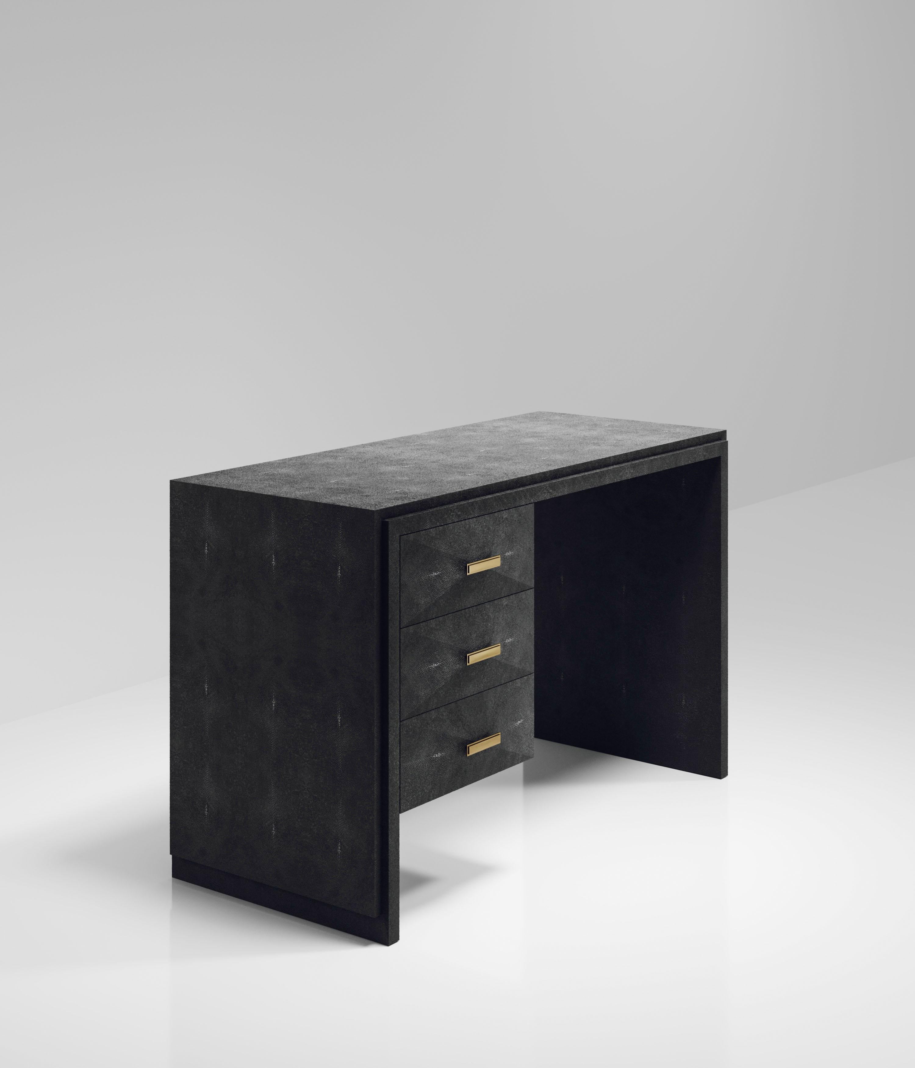 The Iconic Writing Desk is both elegant and minimalist with its classic aesthetic that showcases the purity of the beautiful Augousti craftsmanship. This piece is completely inlaid in black shagreen and includes 3 bevelled drawers on the left side
