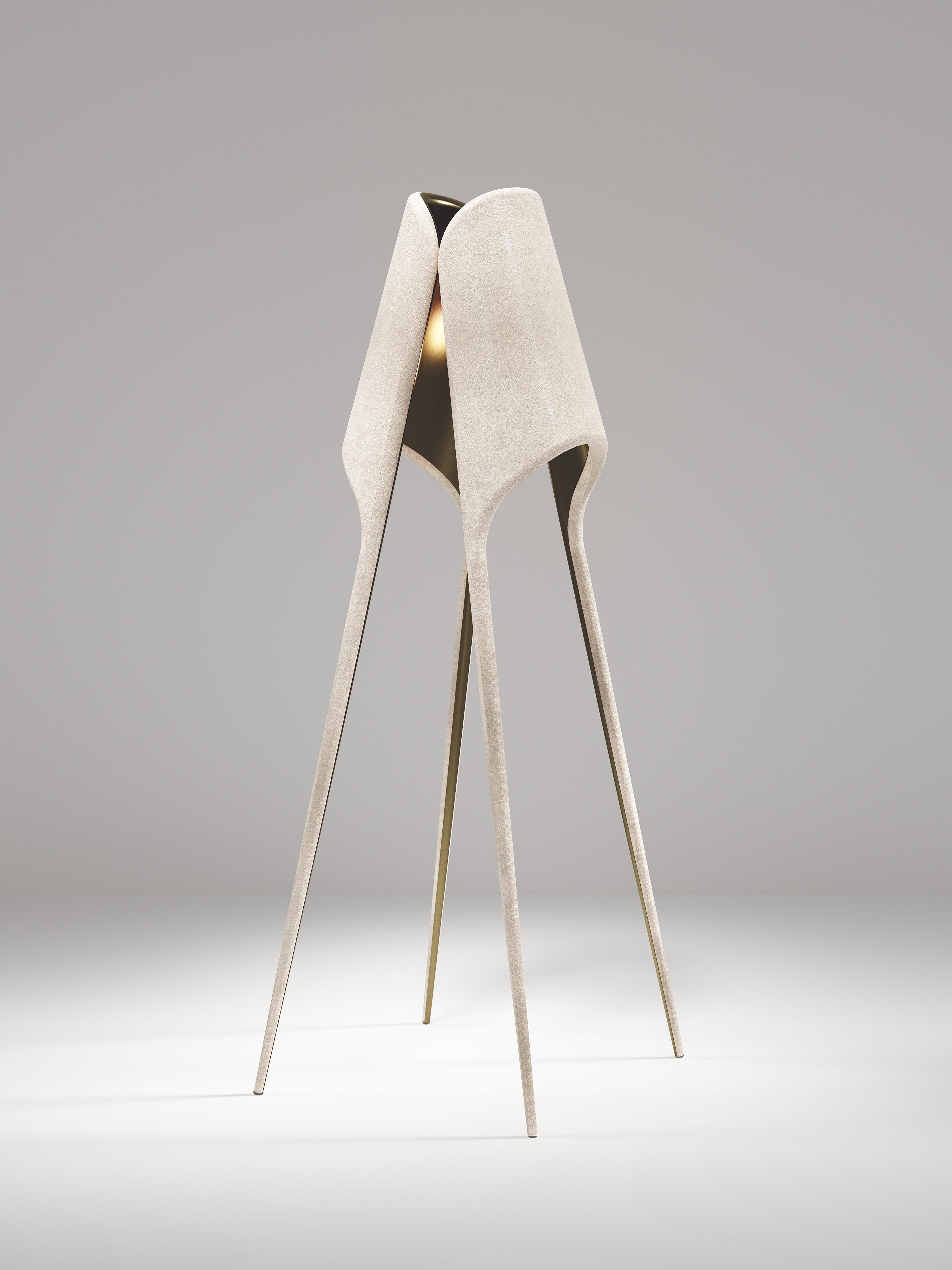 The Frequency Floor Lamp by R & Y Augousti is sleek piece with a vintage-modern feel. The piece explores fluid organic lines with subtle detailing to create the signature Augousti aesthetic. The piece is inlaid in a mixture of cream shagreen and