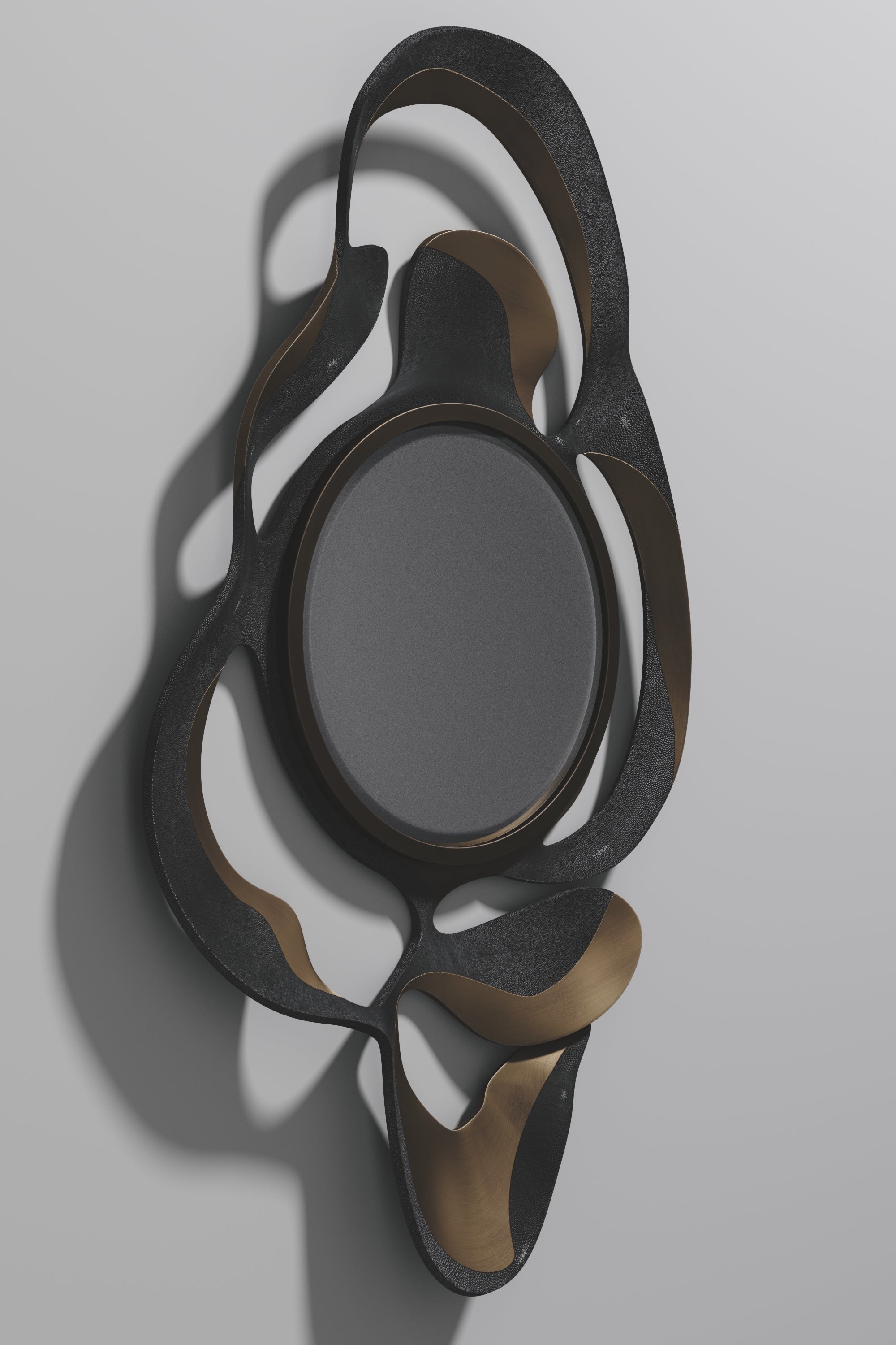 The Leaf Mirror by Kifu Paris is a dramatic and organic piece. The coal black shagreen and bronze-patina bass inlay mixture creates a striking appearance as it emulates a whimsical interpretation of intertwining branches. This piece is designed by
