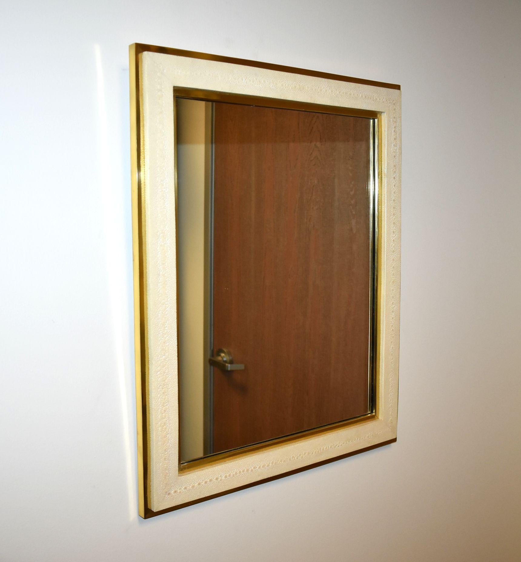 Rectangular mirror cover with beige shagreen and brass frame and detail.