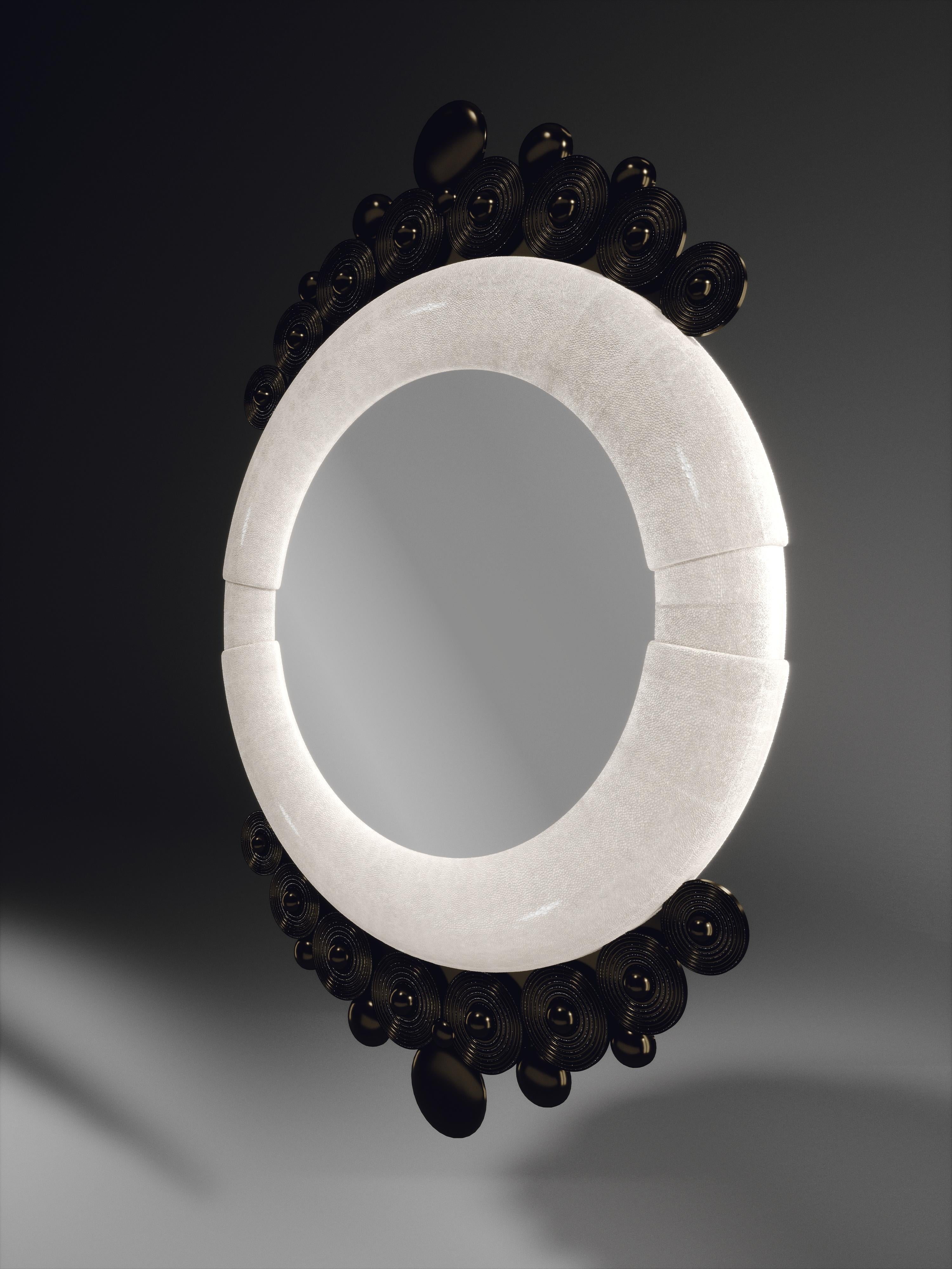 The Atlantis Mirror by R&Y Augousti in cream shagreen and dark bronze-patina brass, is an archive piece of theirs from the 1990s. The statement wall piece adds drama and flair to any space and shows the richness of their incredible artisan work.