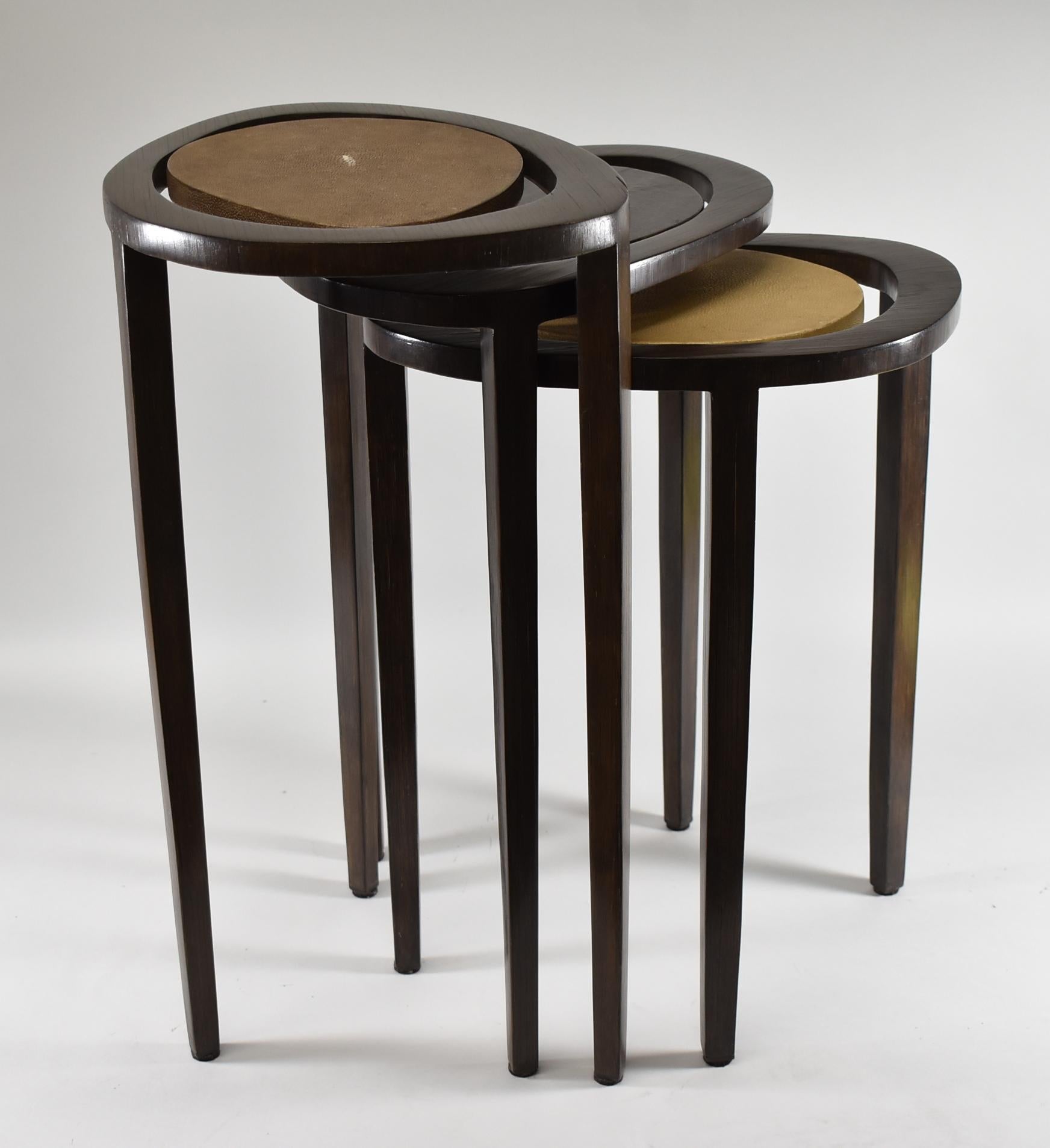 Rosewood and shagreen set of three nesting tables by R&Y Augusti Paris. Free form styled elliptical tops with floating surfaces. Very nice to excellent condition. Dimensions: 14.75