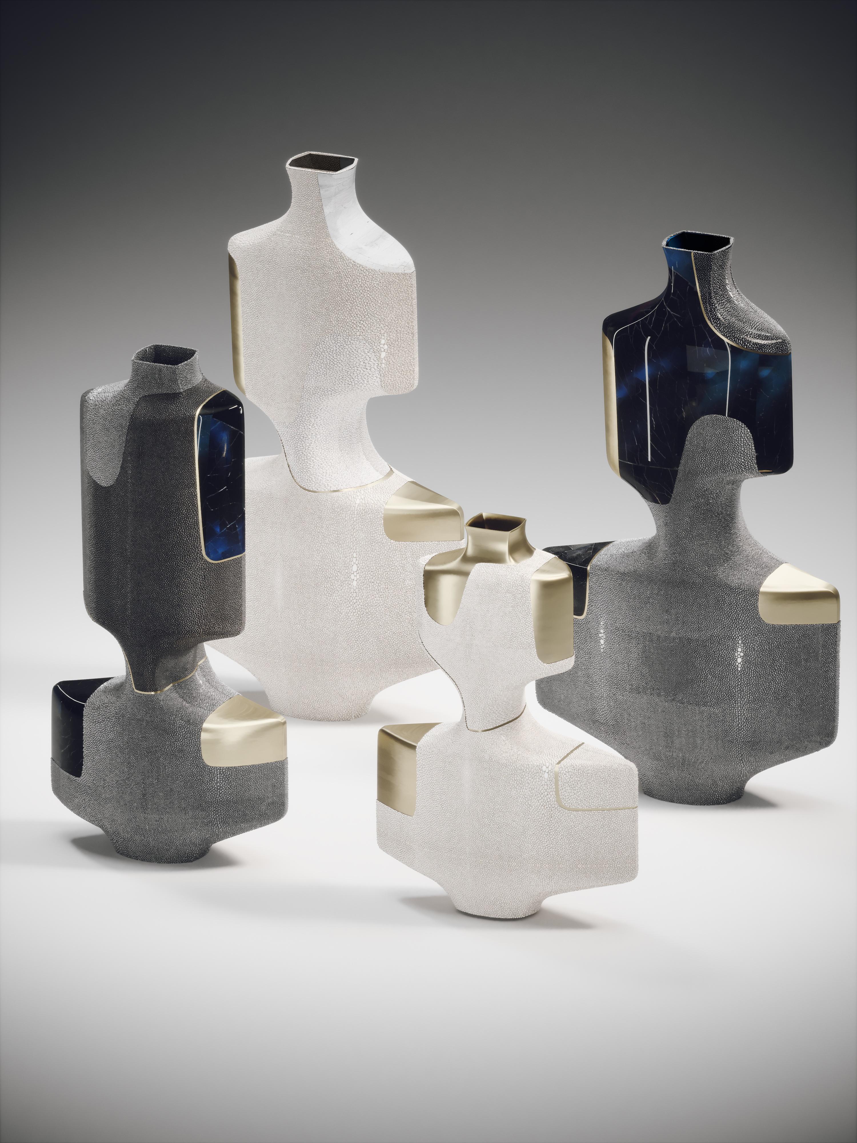 The set of 4 Artemis sculptural vases are graphic pieces that add a statement to any space. The bold pattern is inlaid in a mixture of cream & white shagreen, mother of pearl and bronze-patina brass and coal black shagreen, black pen shell and