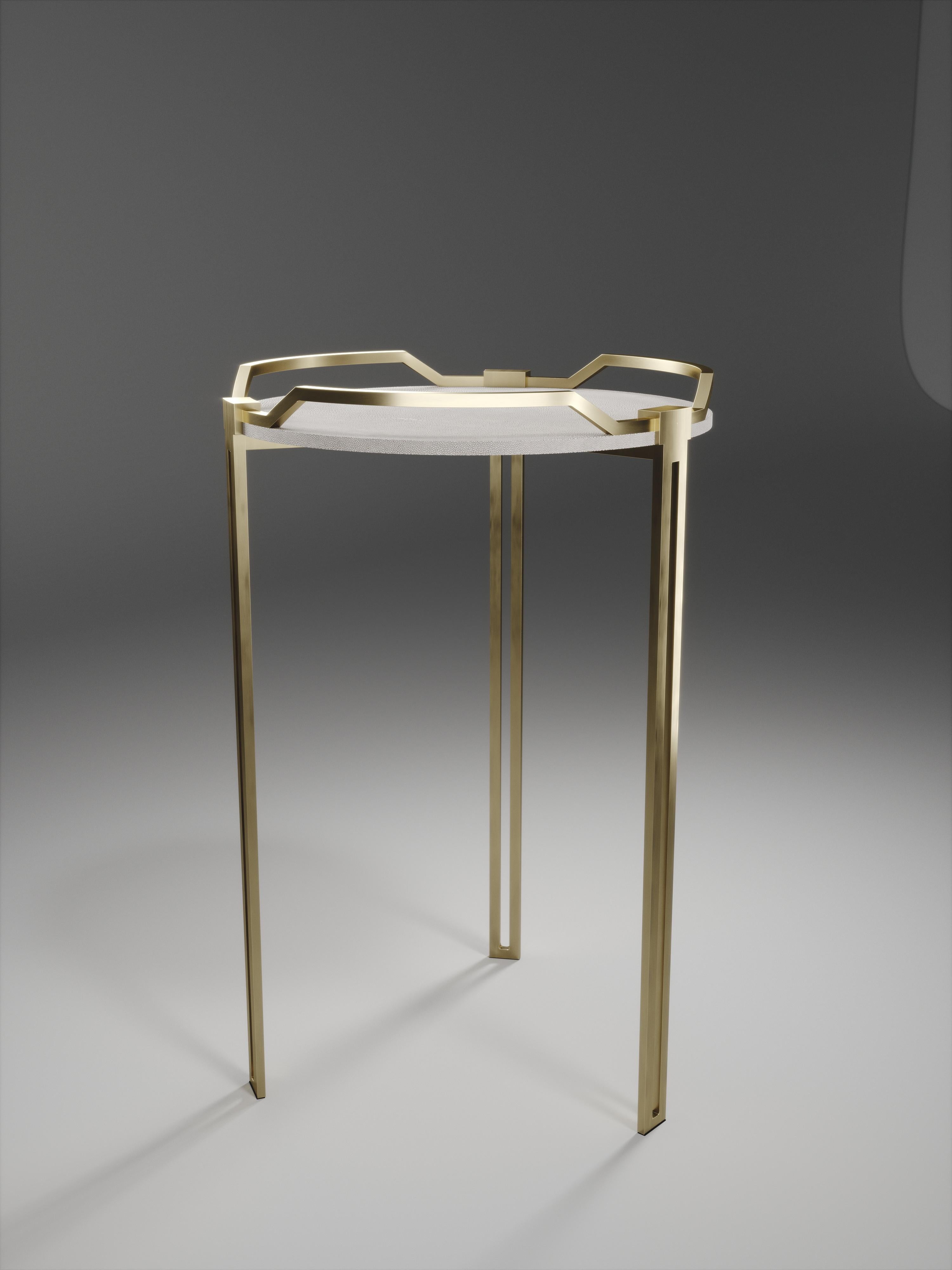 The Soho side table is the perfect piece for a living room, bedroom or office space that merges vintage and modern sensibility. The surface of this end table is inlaid in cream shagreen, framed with a raised bronze-patina brass handles that merge