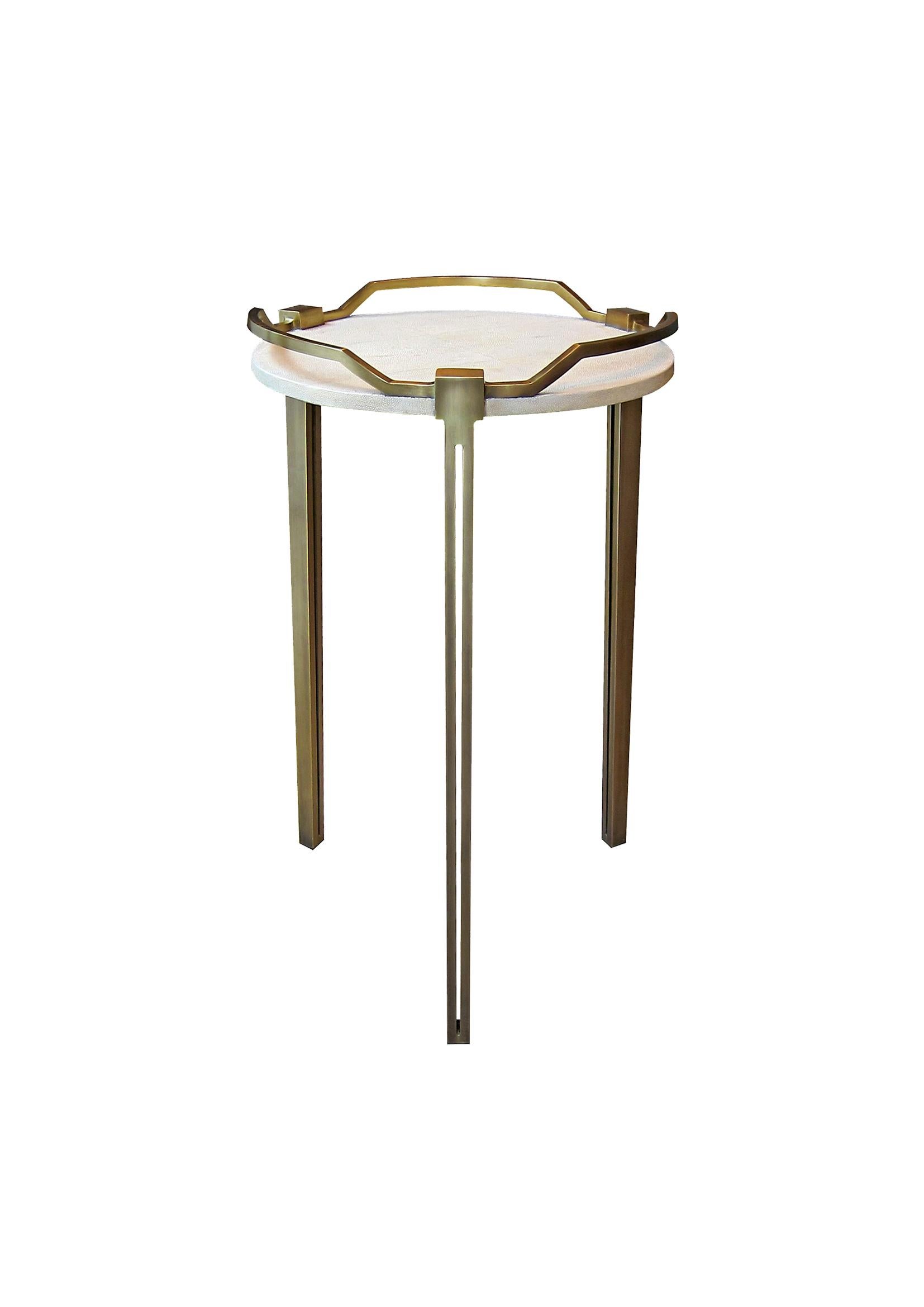The Soho side table is the perfect piece for a living room, bedroom or office space that merges vintage and modern sensibility. The surface of this end table is inlaid in cream shagreen, framed with a raised bronze-patina brass handles that merge