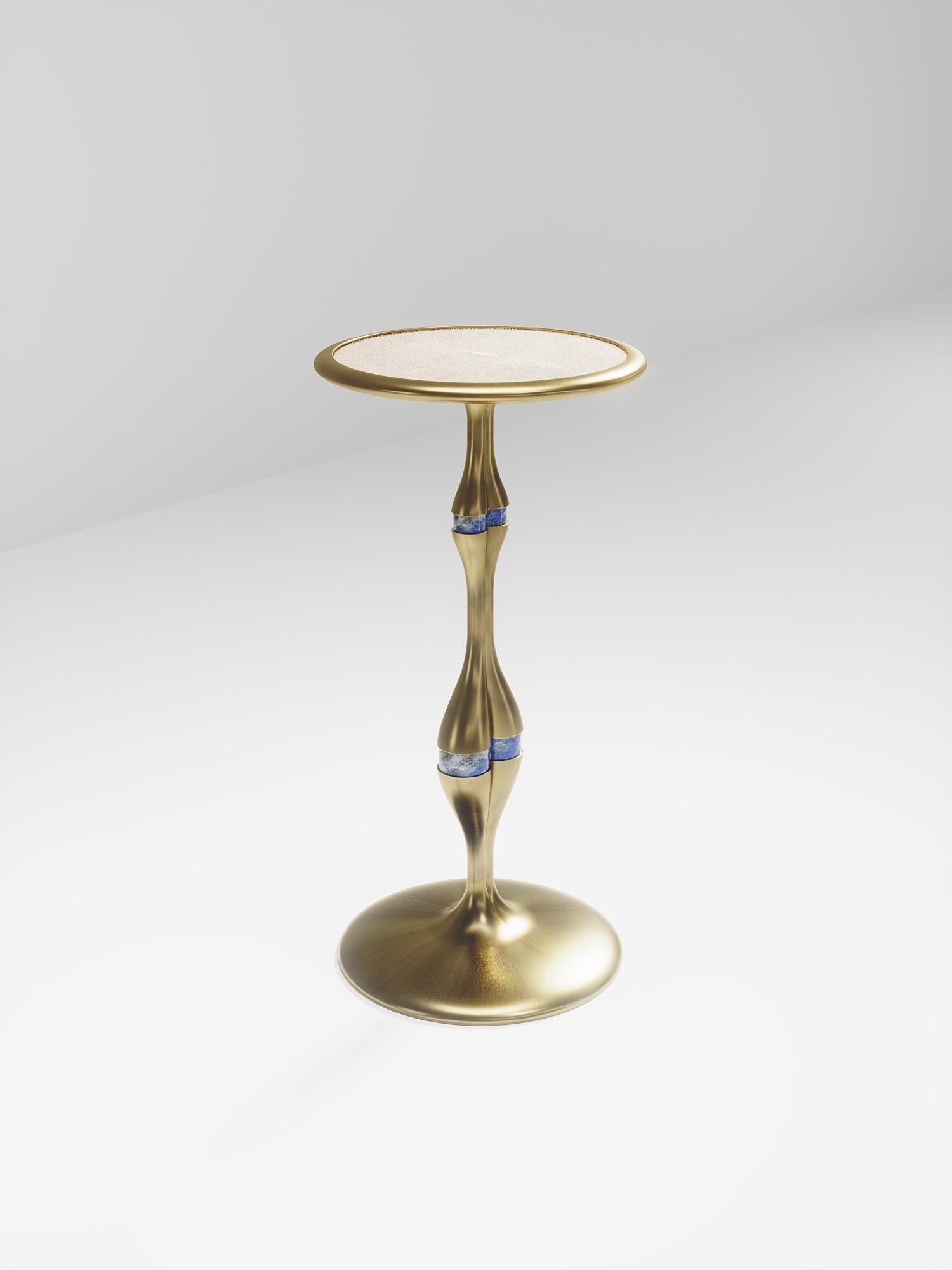 The Frequency side table I by R & Y Augousti is a sleek piece with a vintage-modern feel. The piece explores fluid organic lines with subtle detailing to create the signature Augousti aesthetic. The piece is inlaid in a mixture of cream shagreen and