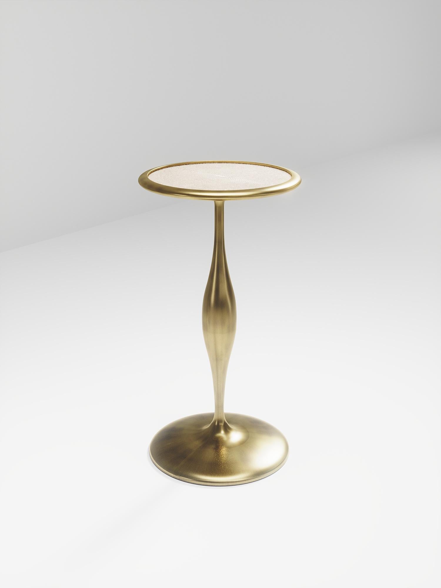 The Frequency side table II by R & Y Augousti is a sleek piece with a vintage-modern feel. The piece explores fluid organic lines with subtle detailing to create the signature Augousti aesthetic. The piece is inlaid in a mixture of cream shagreen