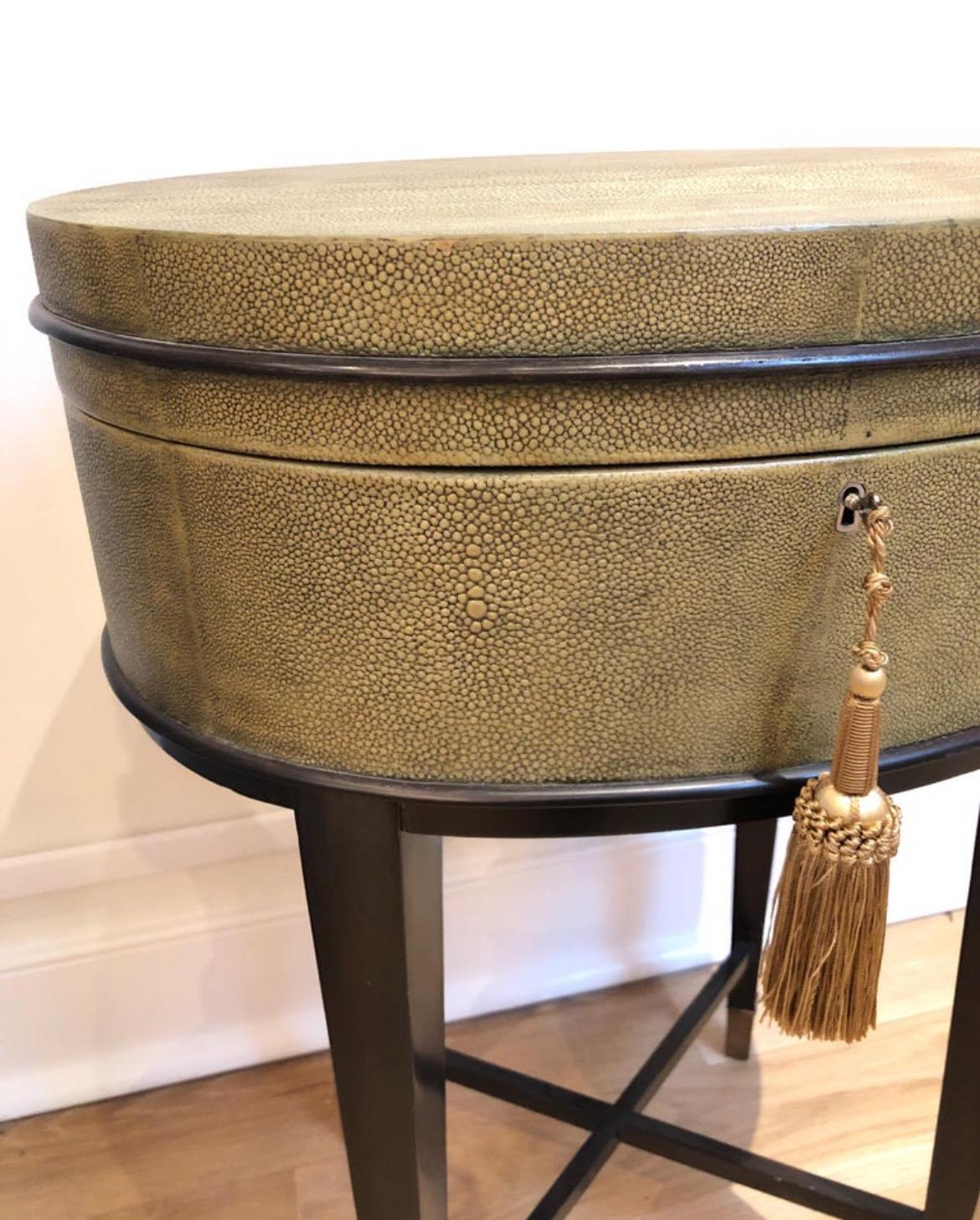 Oval Shaped Faux Shagreen Side Table. Top lifts for storage. Very unique table in great condition.
Brass lock missing key. We have a dummy provided with tassel. 

Attributed/In the Style of R&Y Augousti