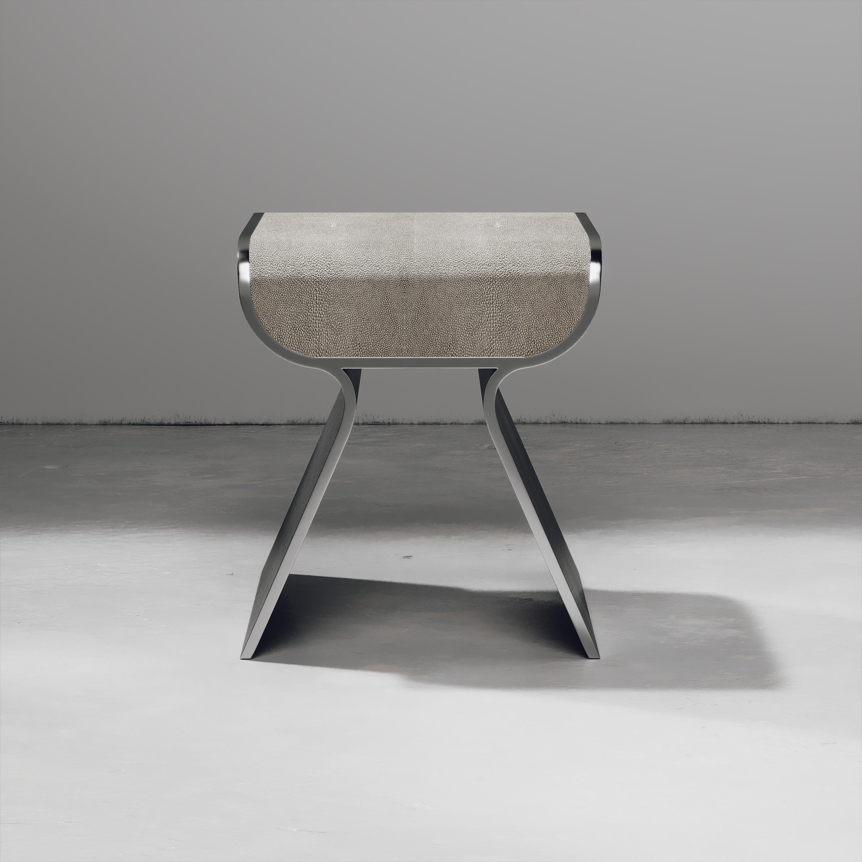 The dandy stool inlaid in cream shagreen is a chic seating piece for any space. The sides of the pieces are completely inlaid in polished steel adding another luxurious and modern element to the piece. Available in other finishes and as a bench, see