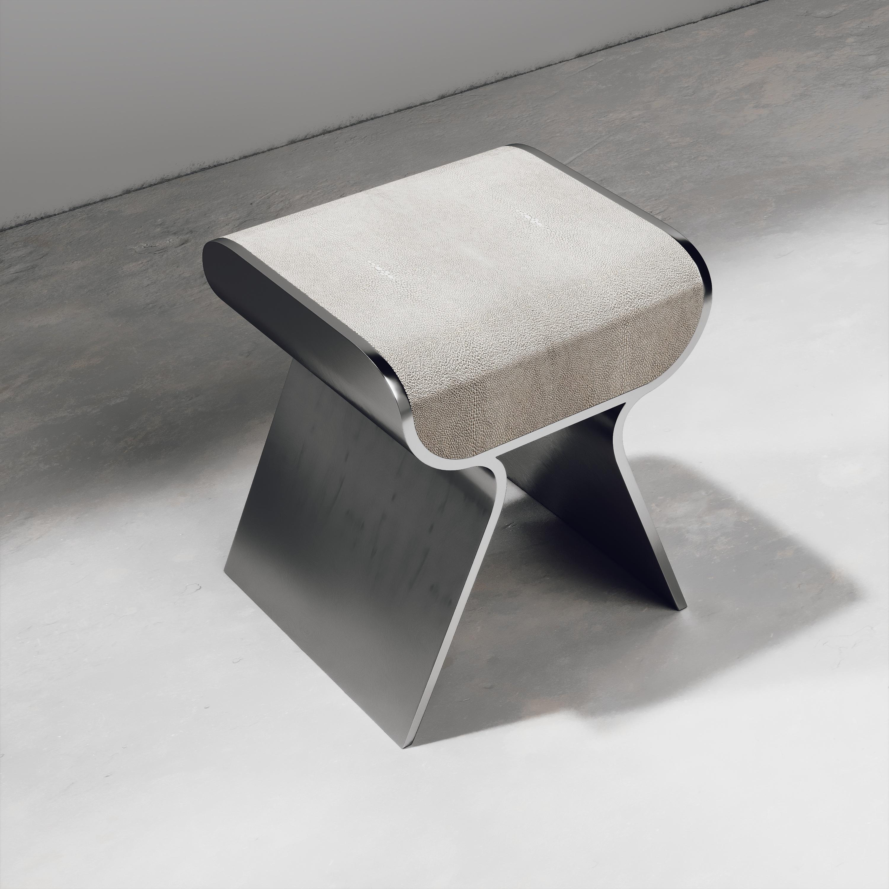 The dandy stool inlaid in cream shagreen is a chic seating piece for any space. The sides of the pieces are completely inlaid in polished steel adding another luxurious and modern element to the piece. Available in other finishes and as a bench, see