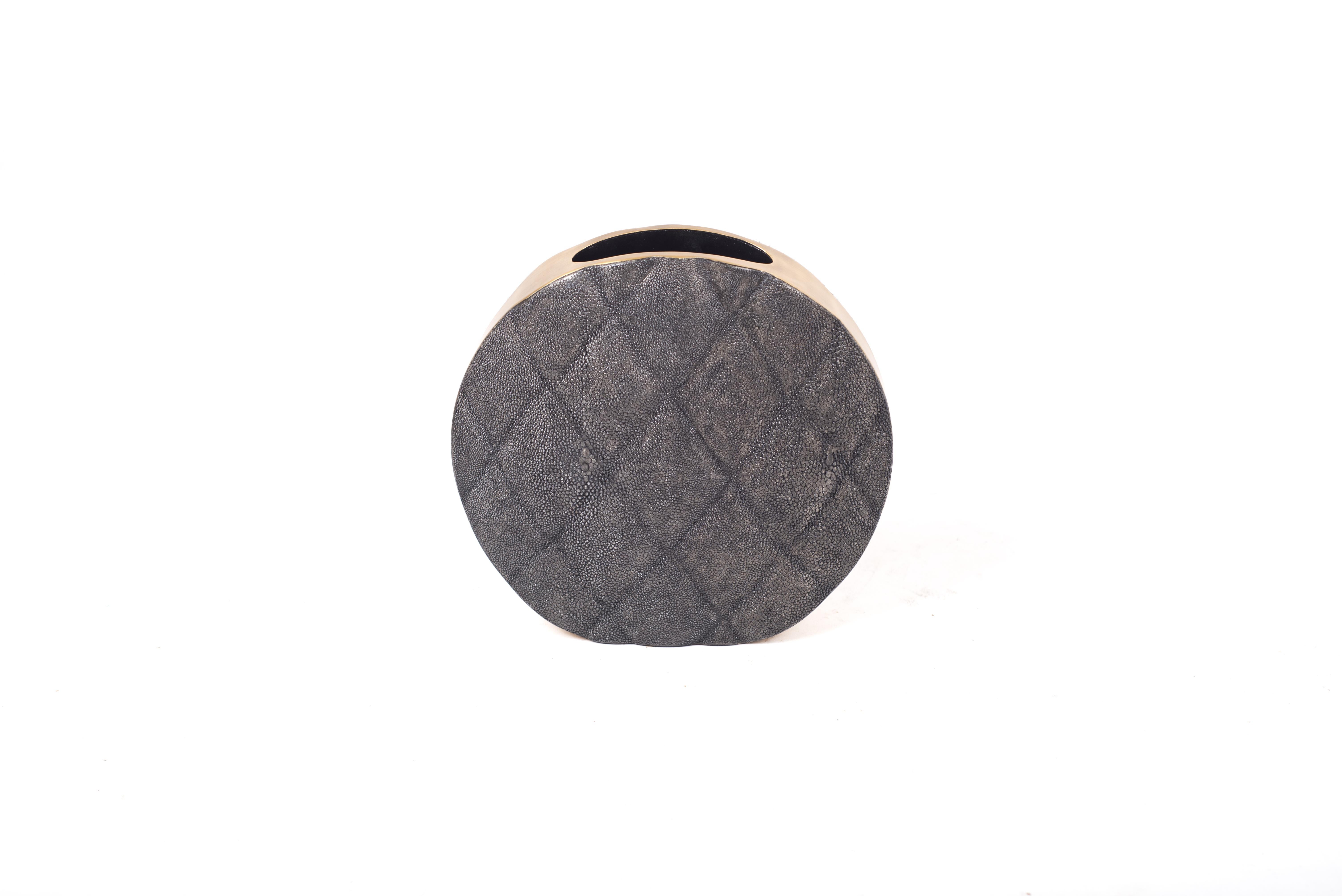 The Coco vase is an elegant piece with its exquisite quilted detailing. This listing is for the medium size inlaid in coal black shagreen with brass details on the side frame. All our vases are inlaid with a fiber-glass interior to support