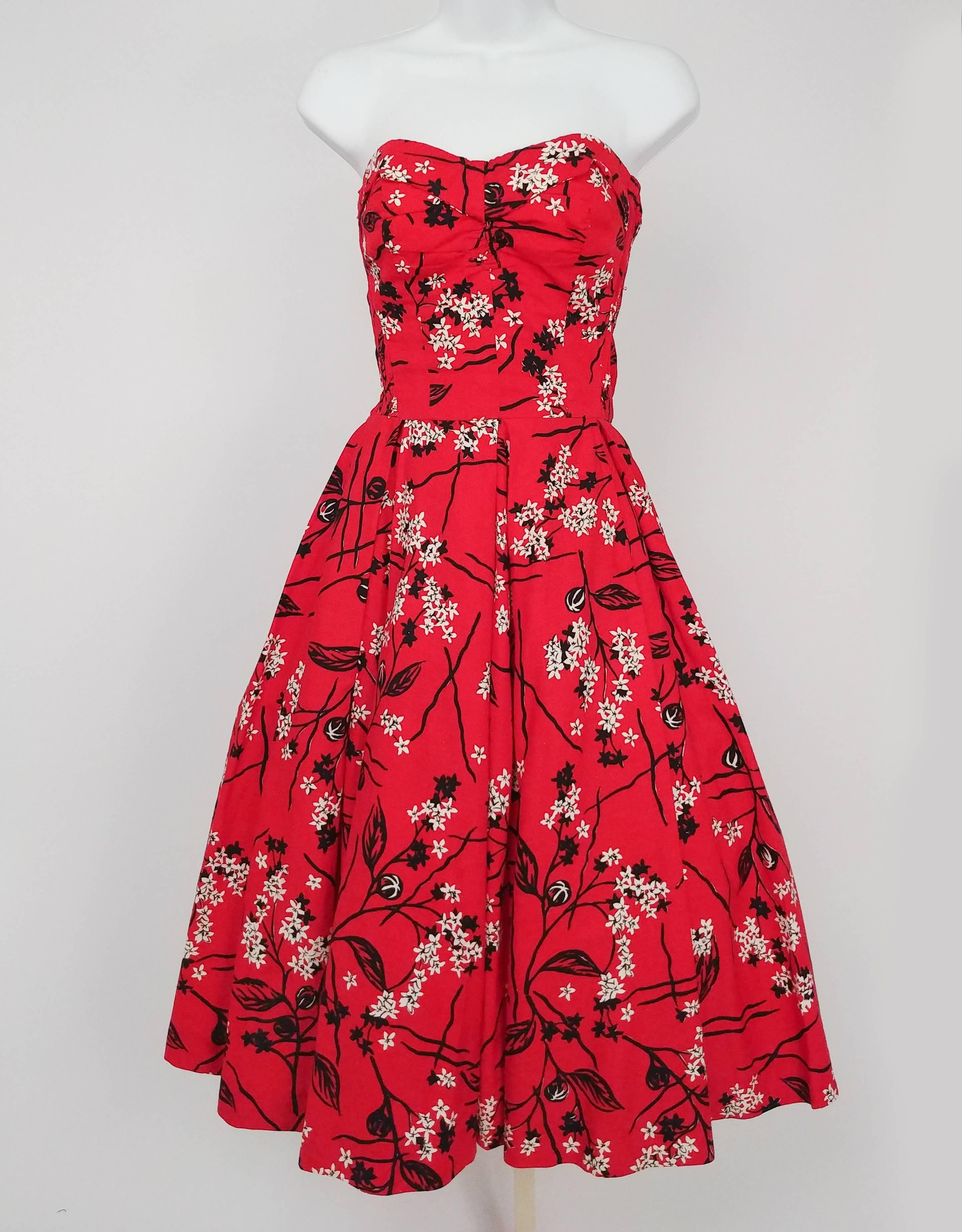 Shaheen Tiki Print Red Dress & Bolero Set, 1950s. Cotton printed tiki set, convertible dress can turn from a halter neck to strapless. Dress pulls on over head, no closures, back is fully shirred. Gathered sweetheart neckline at front. Short sleeve