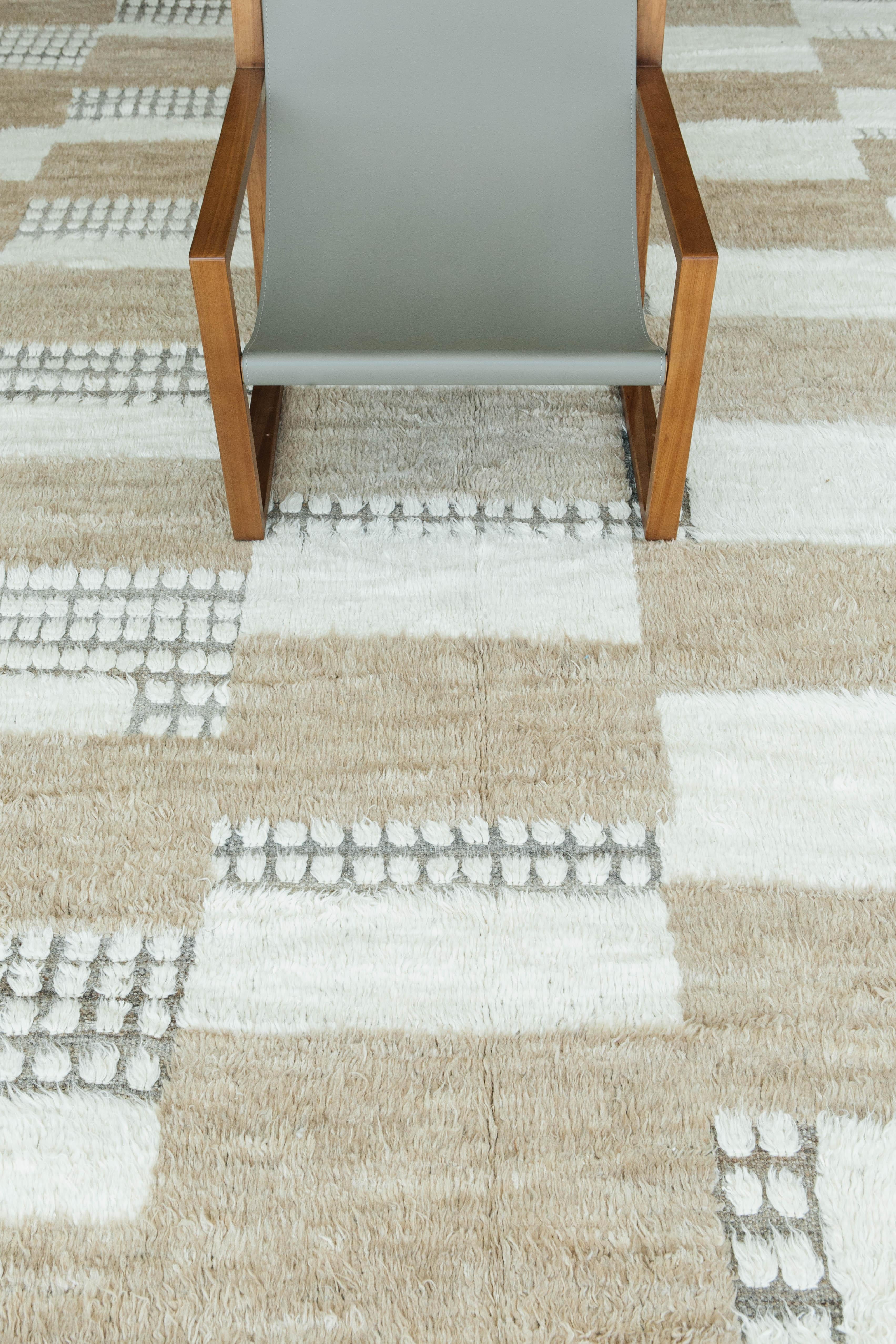 Shahmaran is a color blocking and checkered hand knotted rug that brings movement and light to the space. The design is created with embossed detailing through the low shag pile. Inspired by Scandinavian design elements and designed in Los Angles