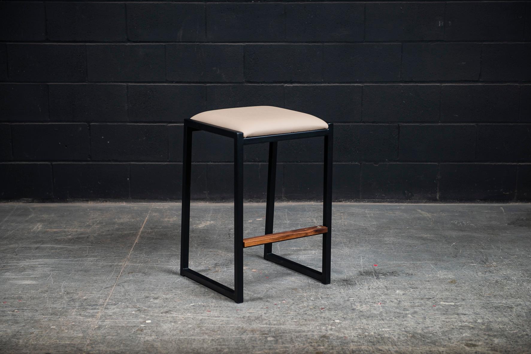 The shaker backless modern counter stool chair is made to order from our unique Ambrozia black textured steel tubing frame and a premium vinyl upholstered seat. Leather is available in option. Inspired by the boarding ladder steps of an old boat.