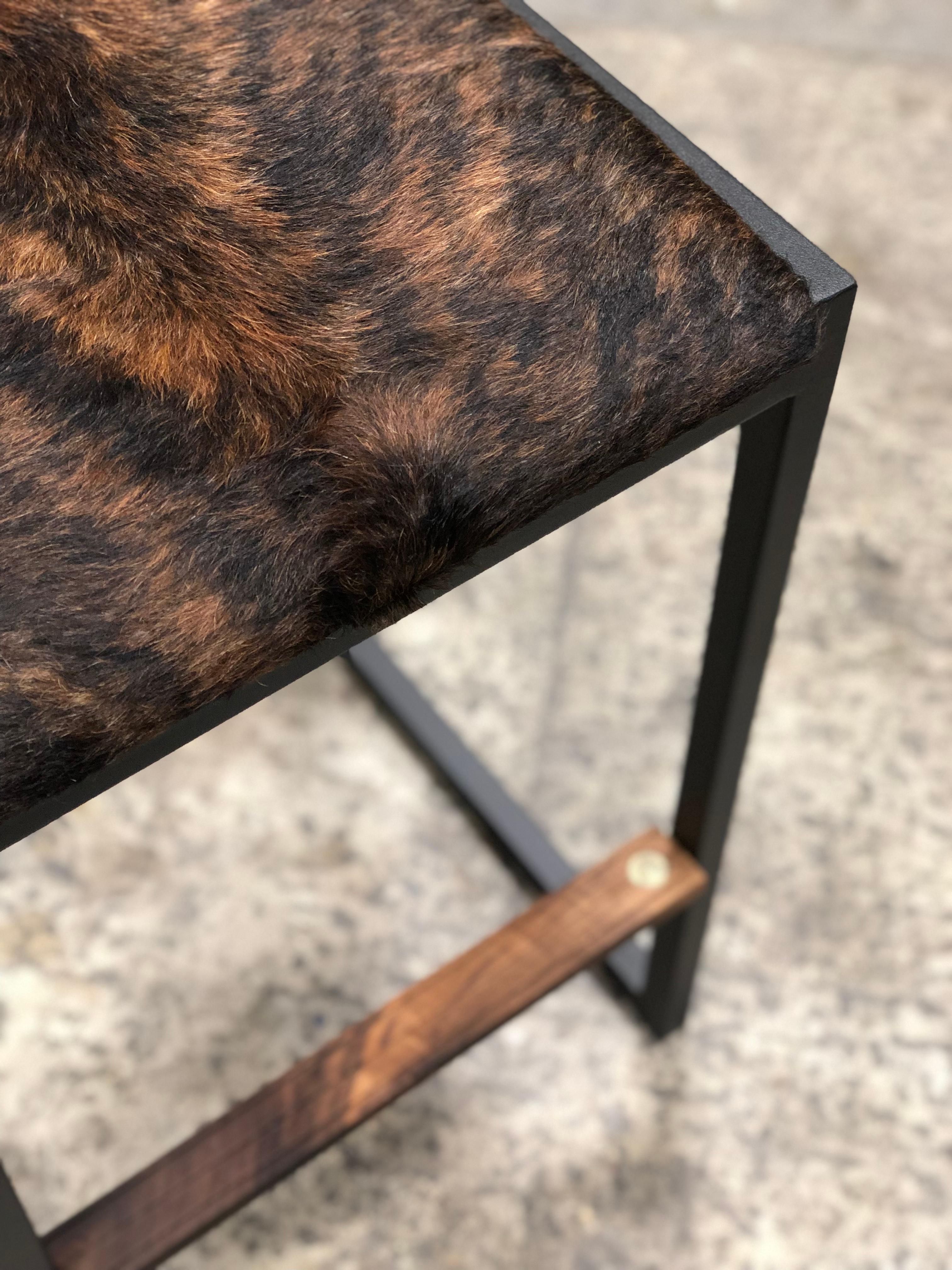 The shaker backless modern counter stool chair is made to order from our unique Ambrozia black textured steel tubing frame and a cowhide upholstered seat. Leather & vinyl is also available . Inspired by the boarding ladder steps of an old boat. The