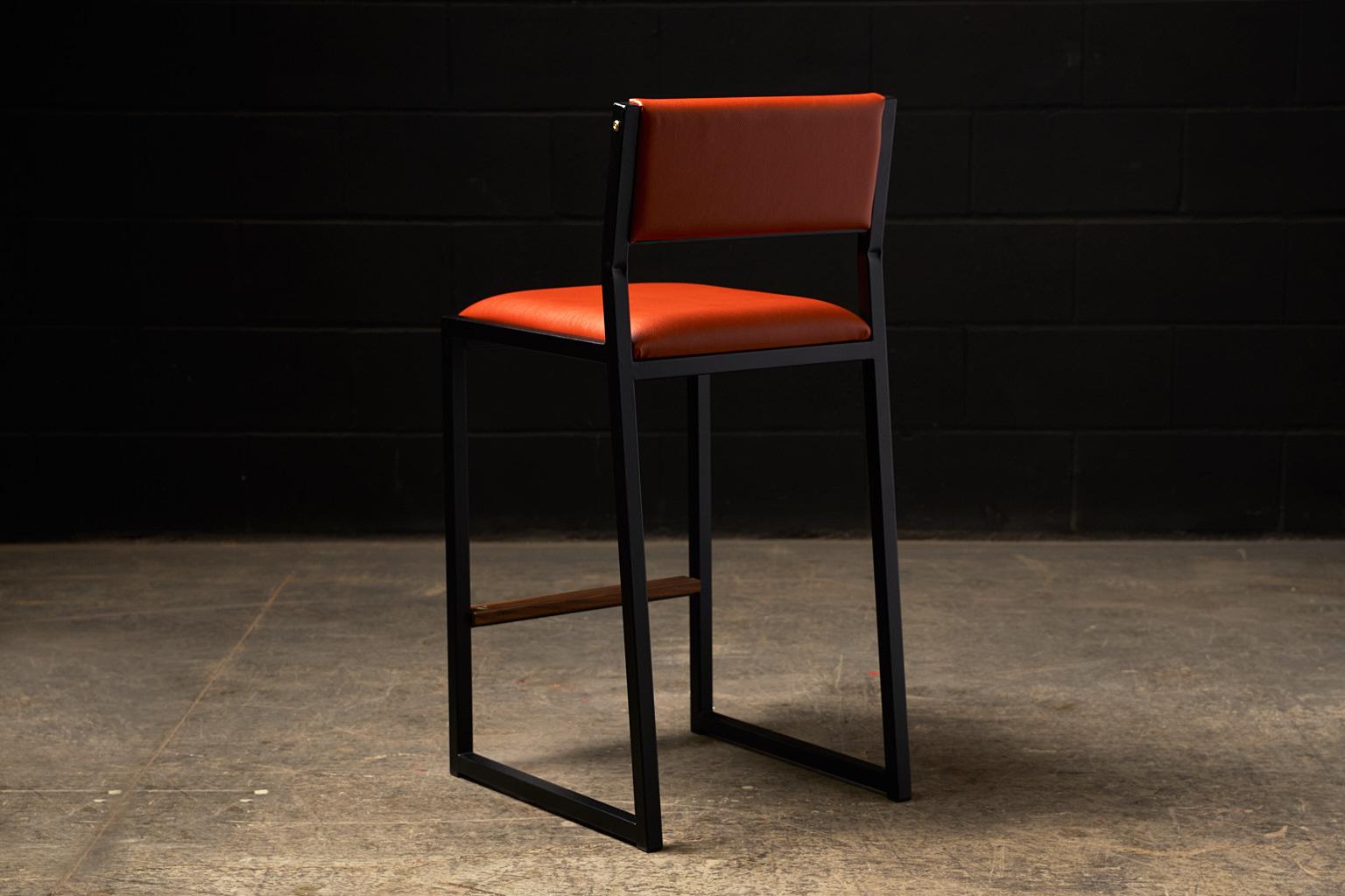 The shaker modern counter stool chair is handmade to order from our unique Ambrozia black textured steel tubing frame and a premium vinyl upholstered seat and back. Leather is available in option. Inspired by the boarding ladder steps of an old